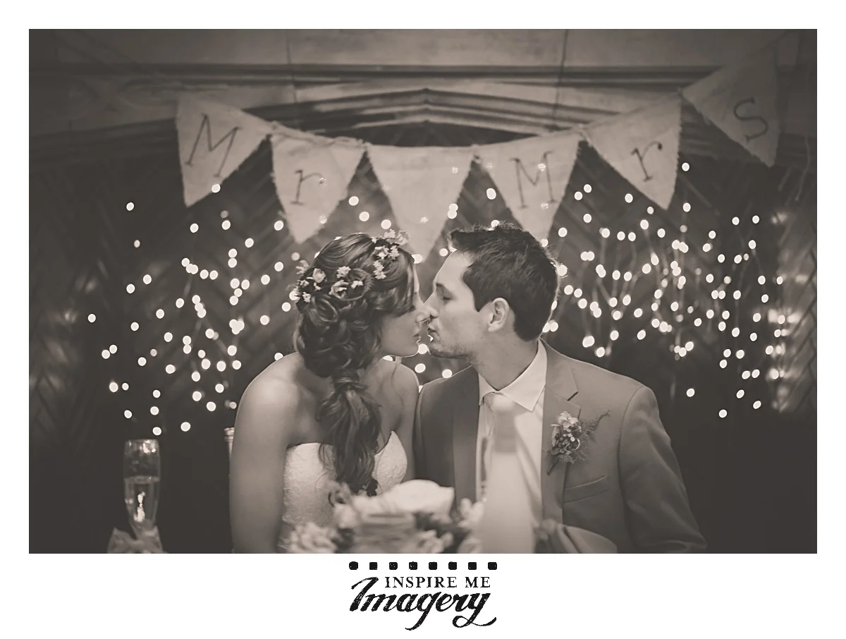 A quick kiss at the sweetheart table in front of their beautiful decor. We wish them all the best.