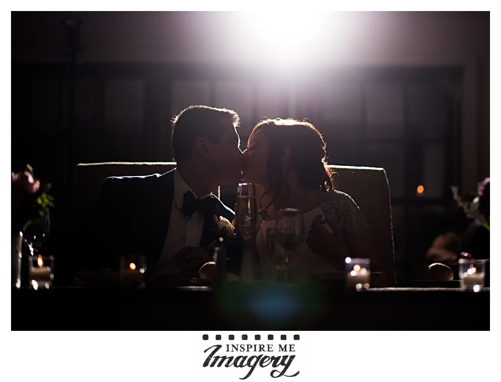 A brief kiss at their sweetheart table.