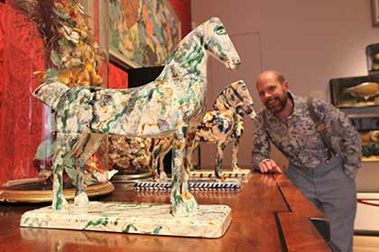Mark Hearld with ceramic horses in The Lumber Room , York Art Gallery, 2015