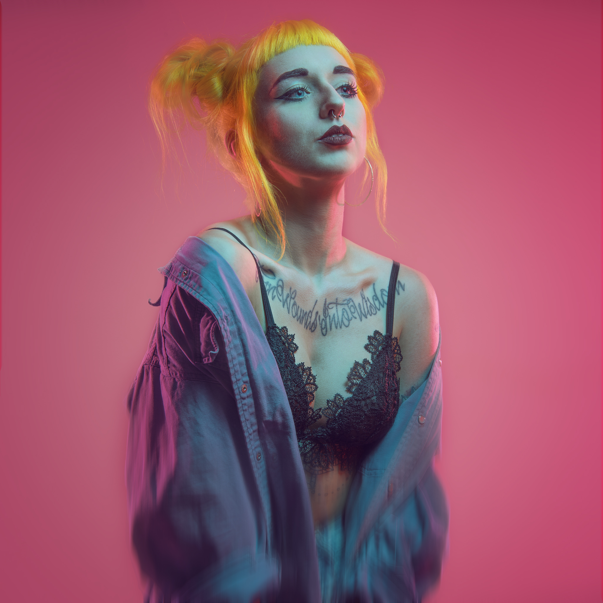 Colour Studio Portrait of Ivana at Deadly Studios Finglas. There is a pink background and a blue light on her face.