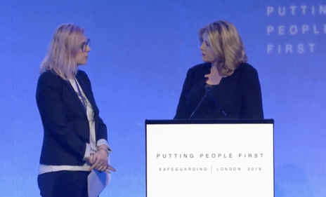 Alexia Pepper de Caires (left) disrupts UK Minister Penny Mordaunt’s keynote speech at the International Safeguarding Summit. (Photo: Screenshot of DFID International Safeguarding Summit)