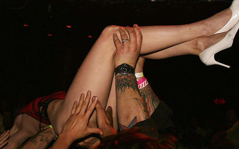 Diamondback Annie stage-diving during a burlesque performance. The stage was so high she fainted as she fell backwards, & awoke in the back of the room, still crowd-surfing. Her music was still on, so she swam back to the stage to finish the act. Photo taken at the Rock & Roll Stripshow by Dan Hendricks.