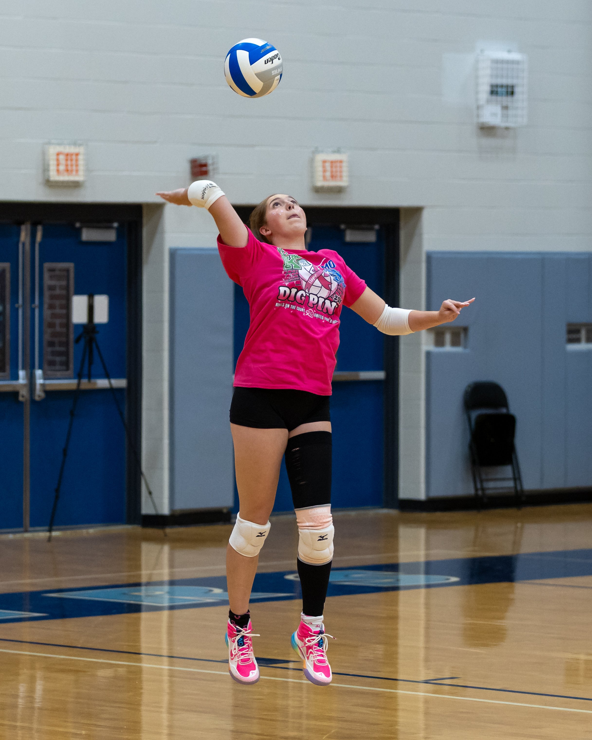 Kettering player serves the ball