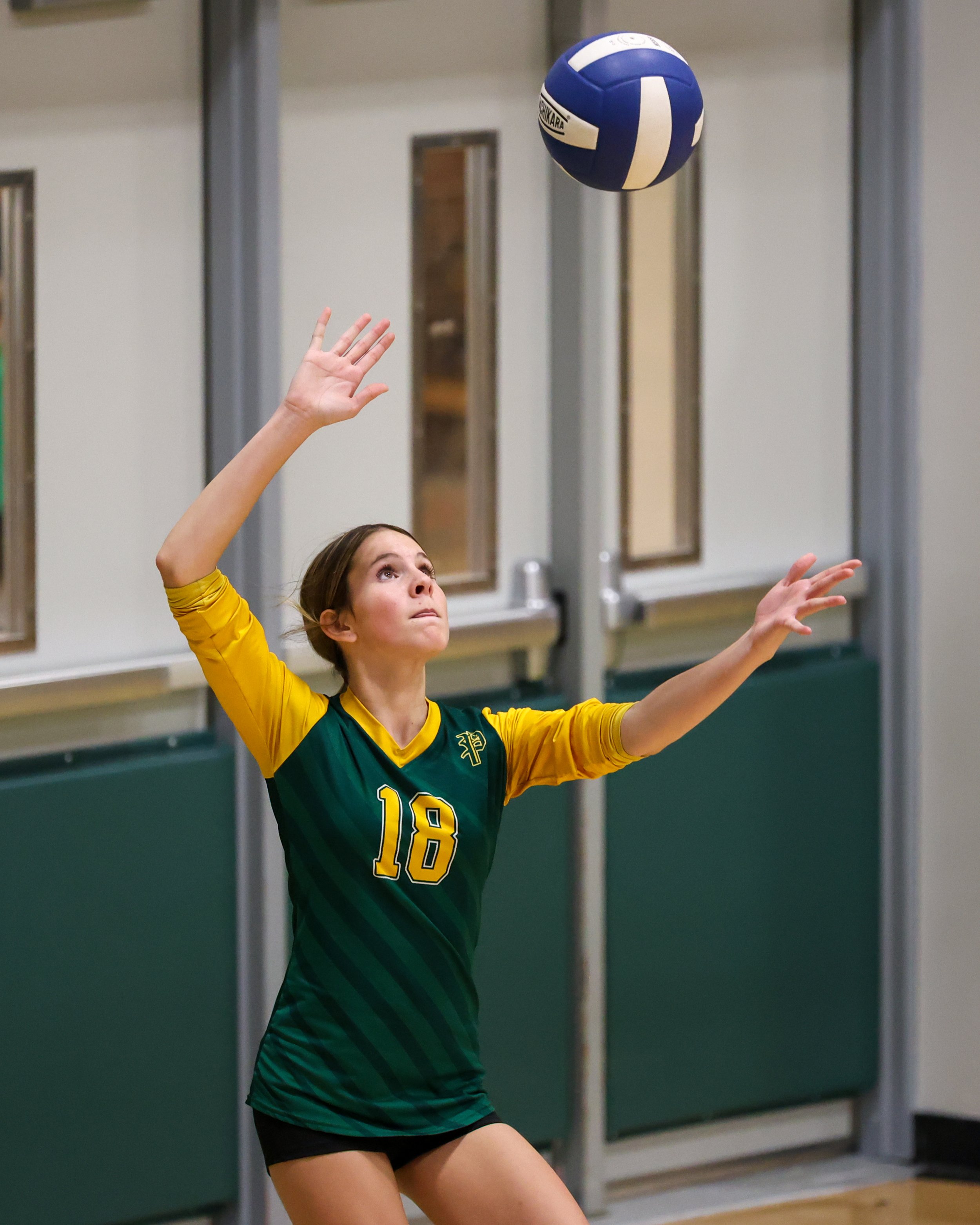 Pierce girl serves the ball