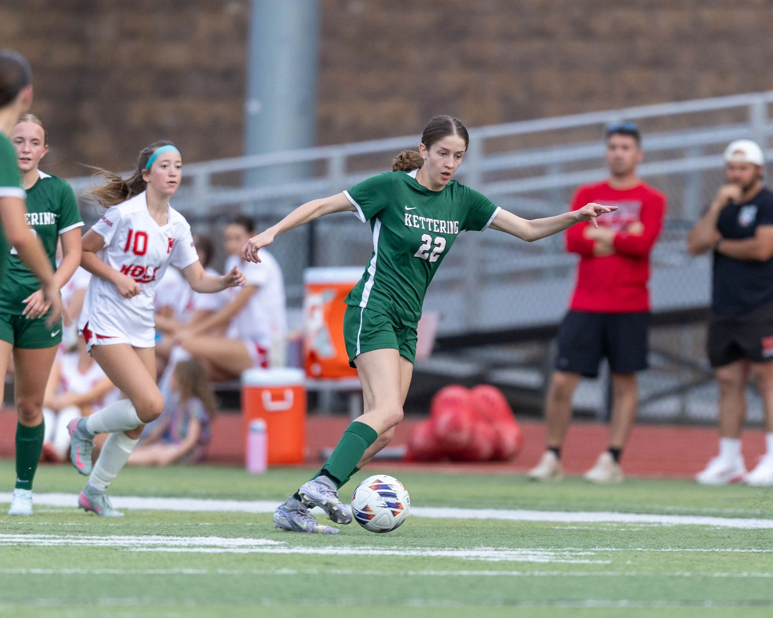 #22 dribbles the ball past a defender