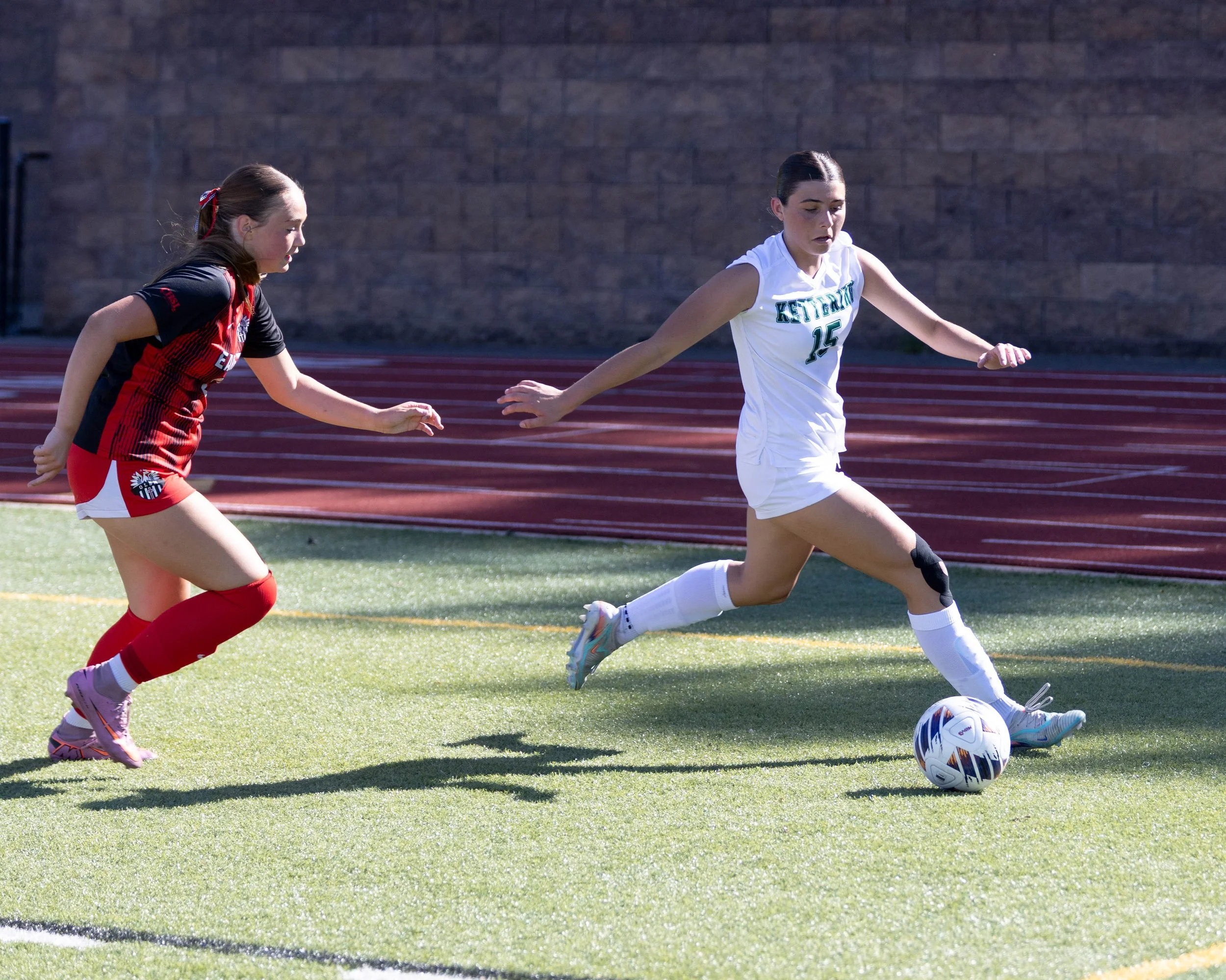 #15 controls the ball around an opponent