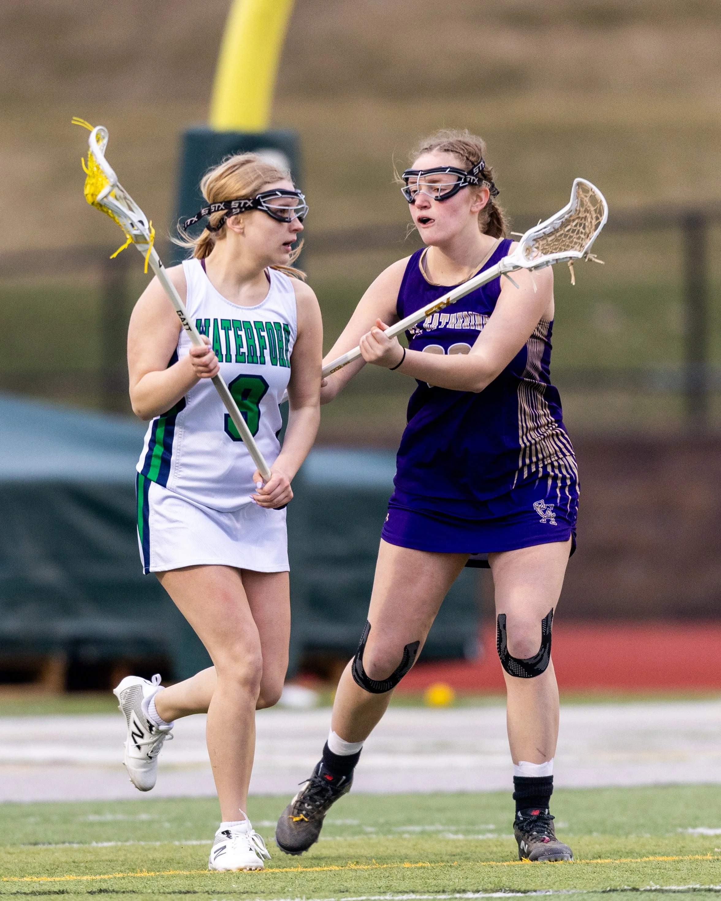 #9 carries the ball with a defender