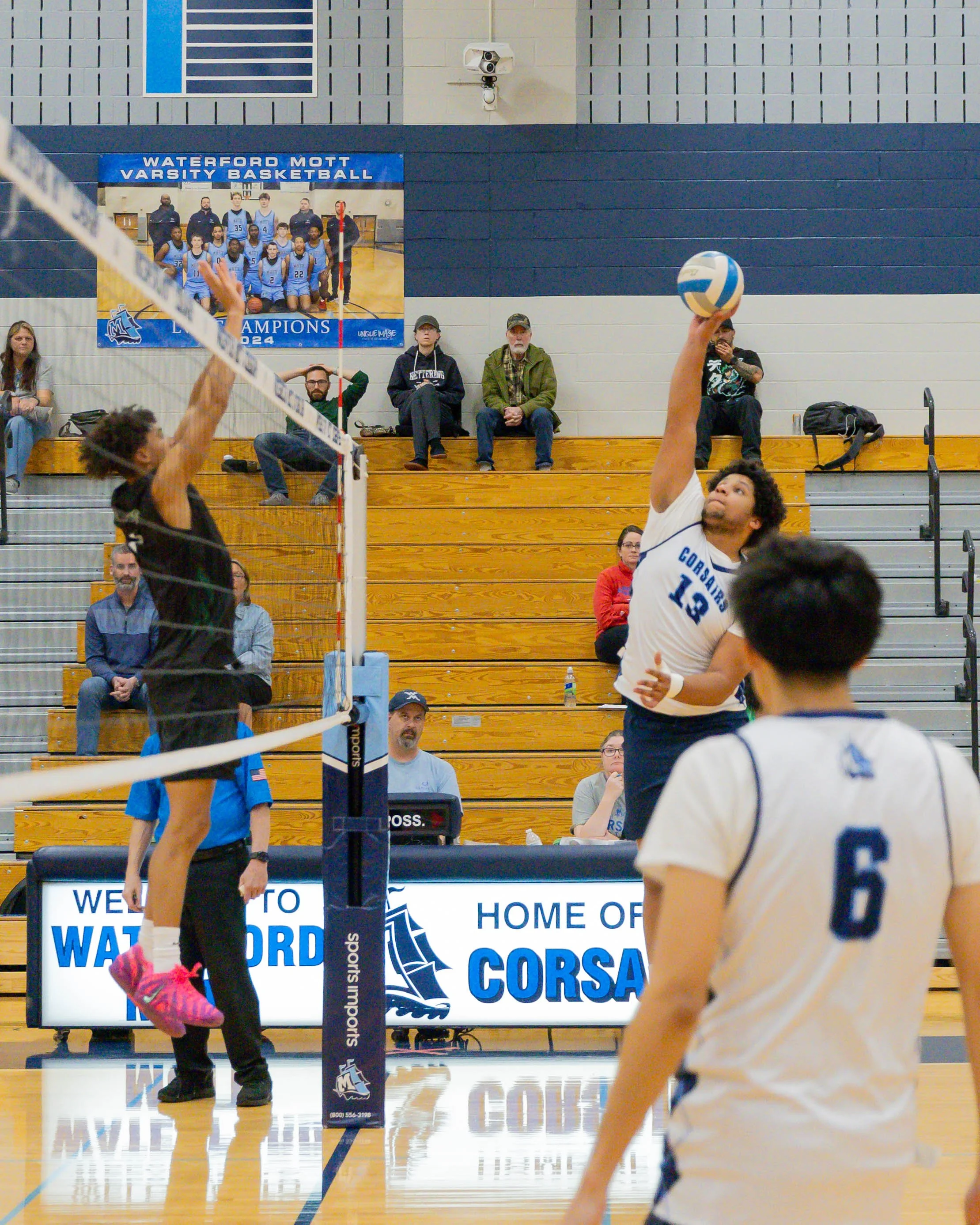 Mott #13 spikes the ball