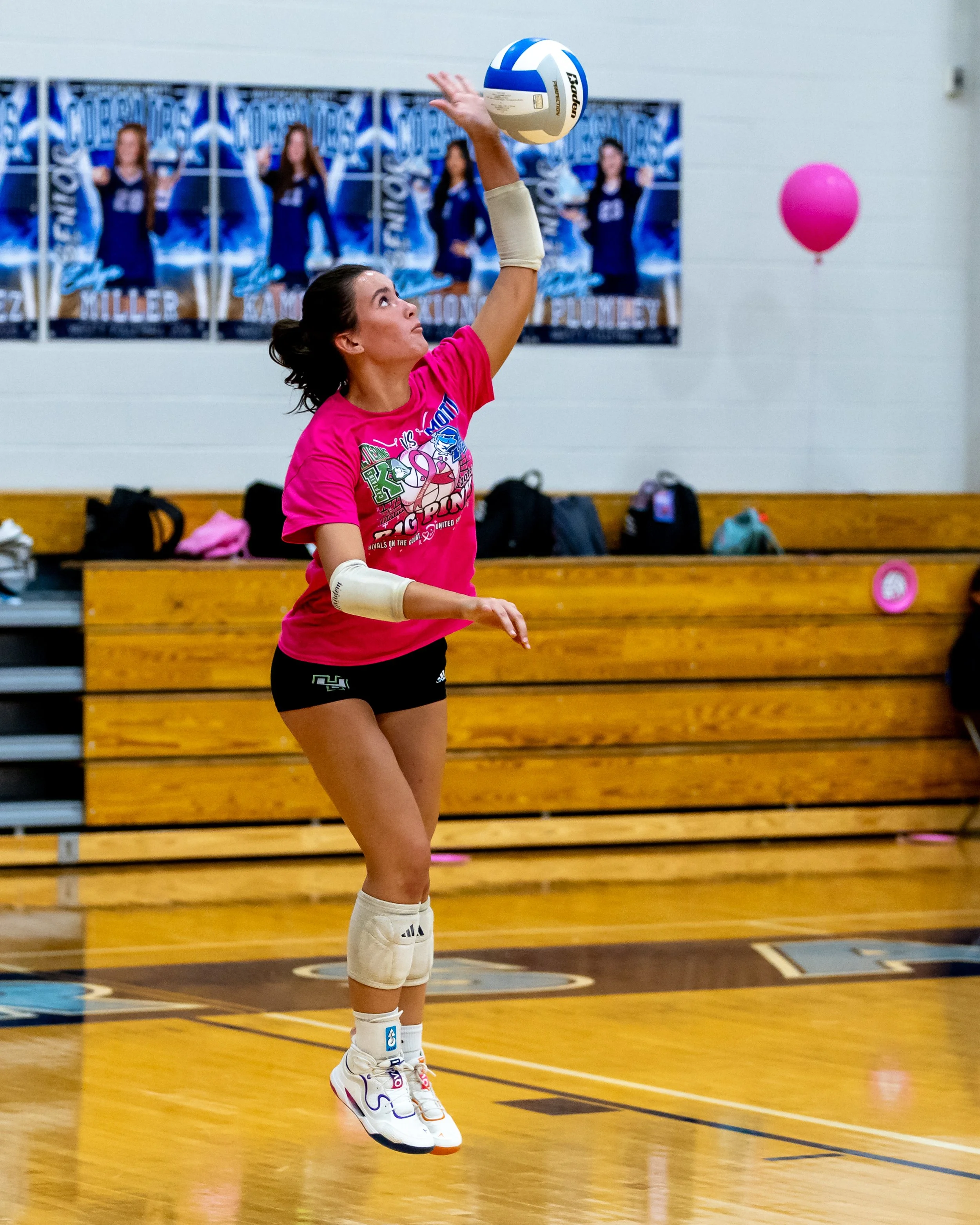 Kettering player serves the ball