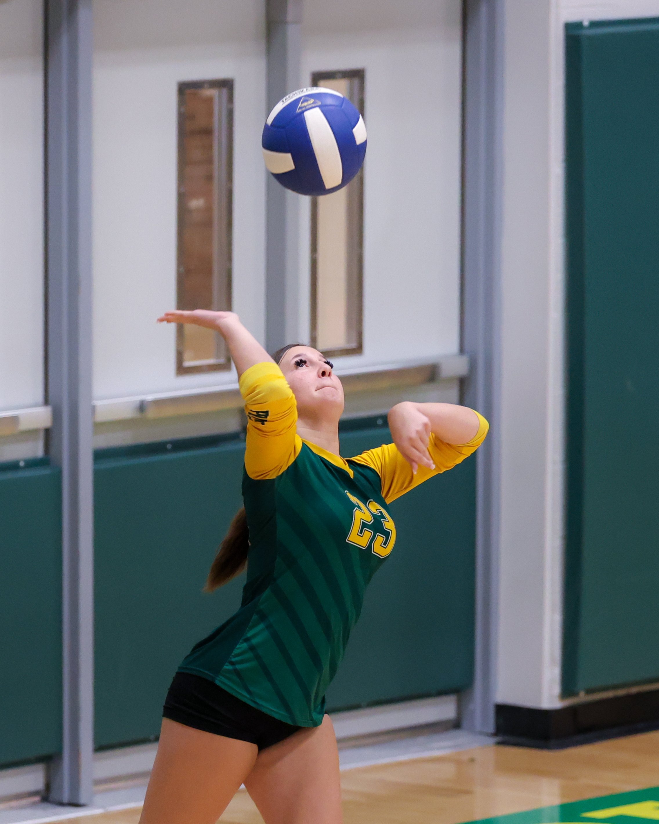 Pierce girl serves the ball