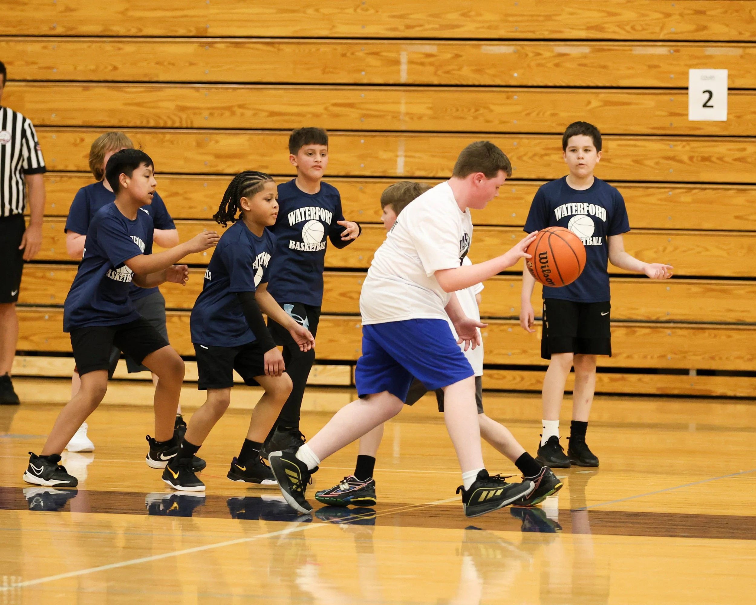 Beaumont boy dribbles ball with Donelson Hills boys around him