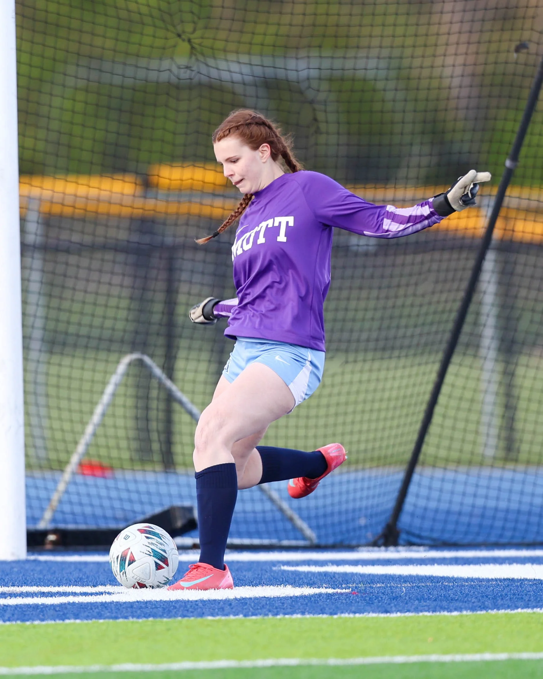 #10 kicks the ball away from the goal