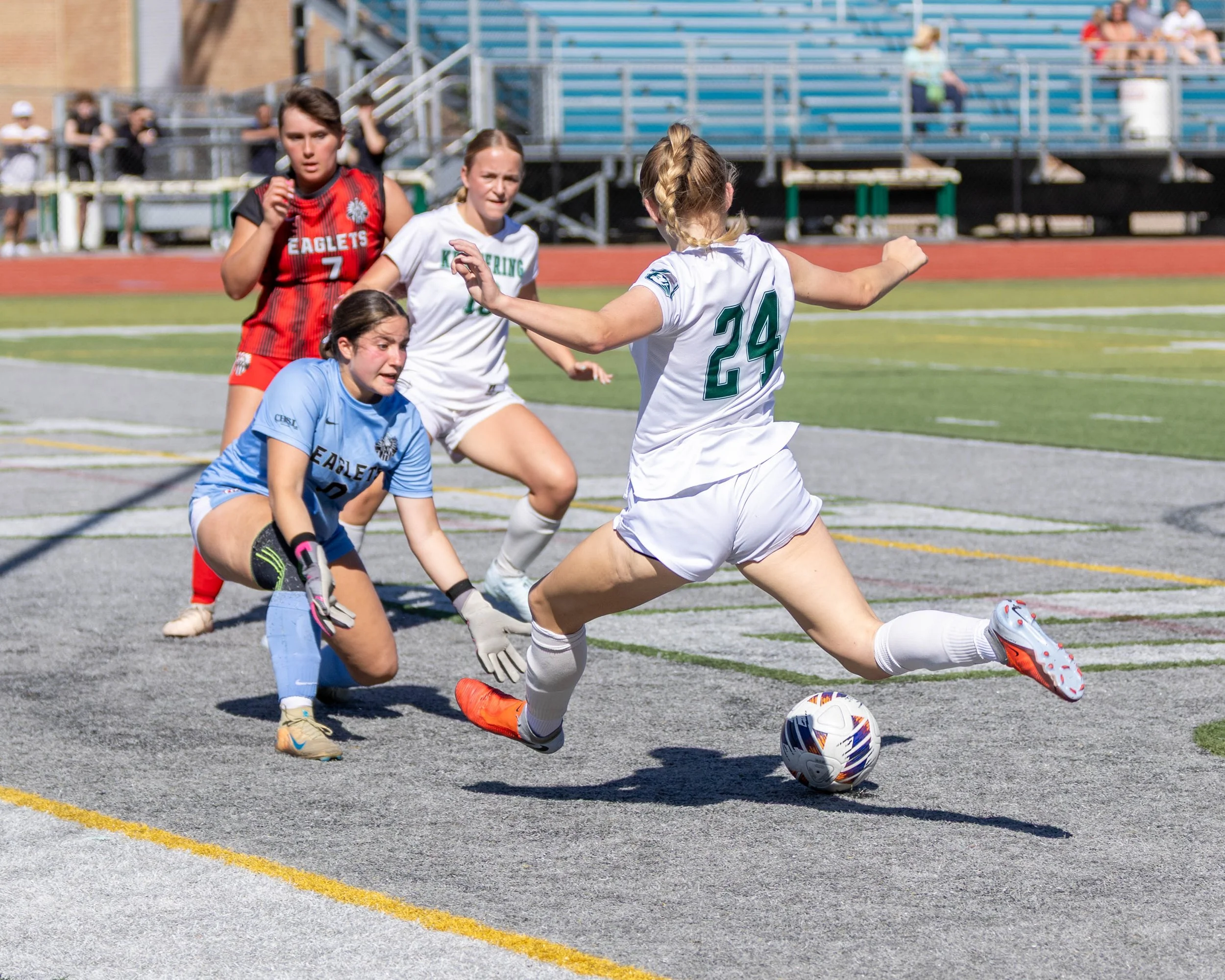 #24 shoots the ball at the goalie