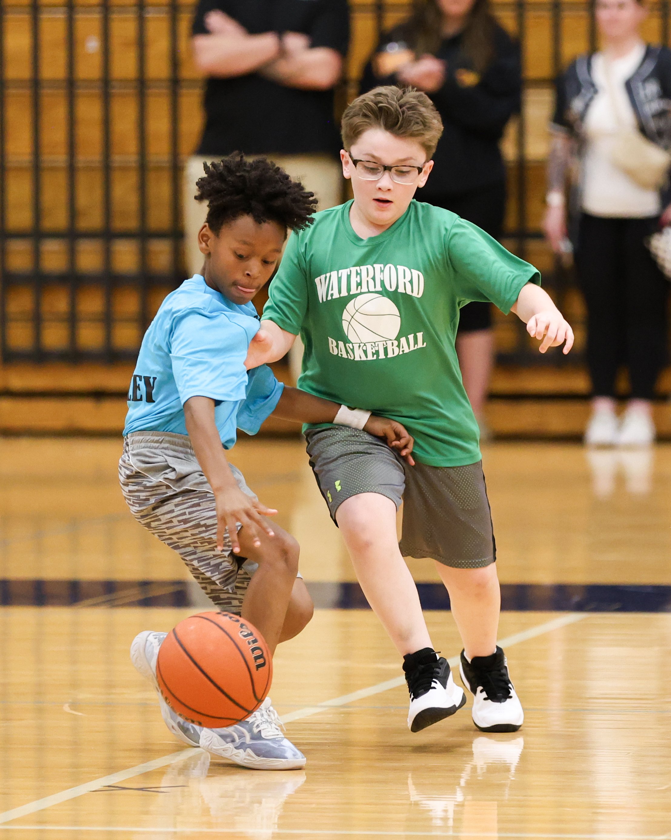 Cooley boy dribbles the ball guarded by Grayson boy