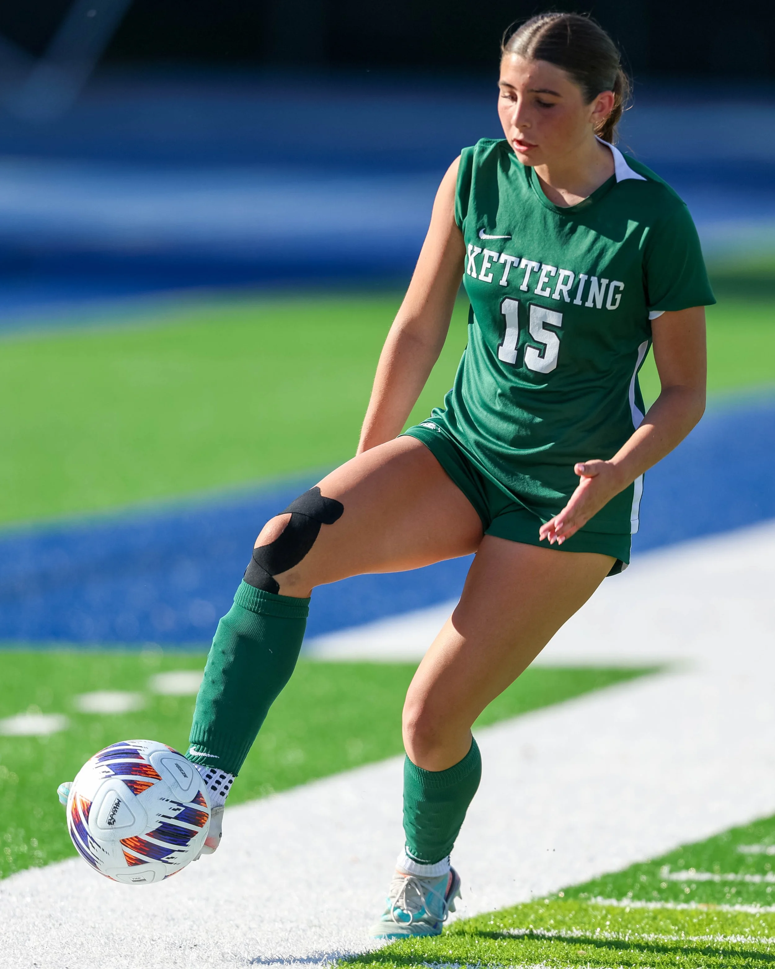 #15 controls the ball with her foot