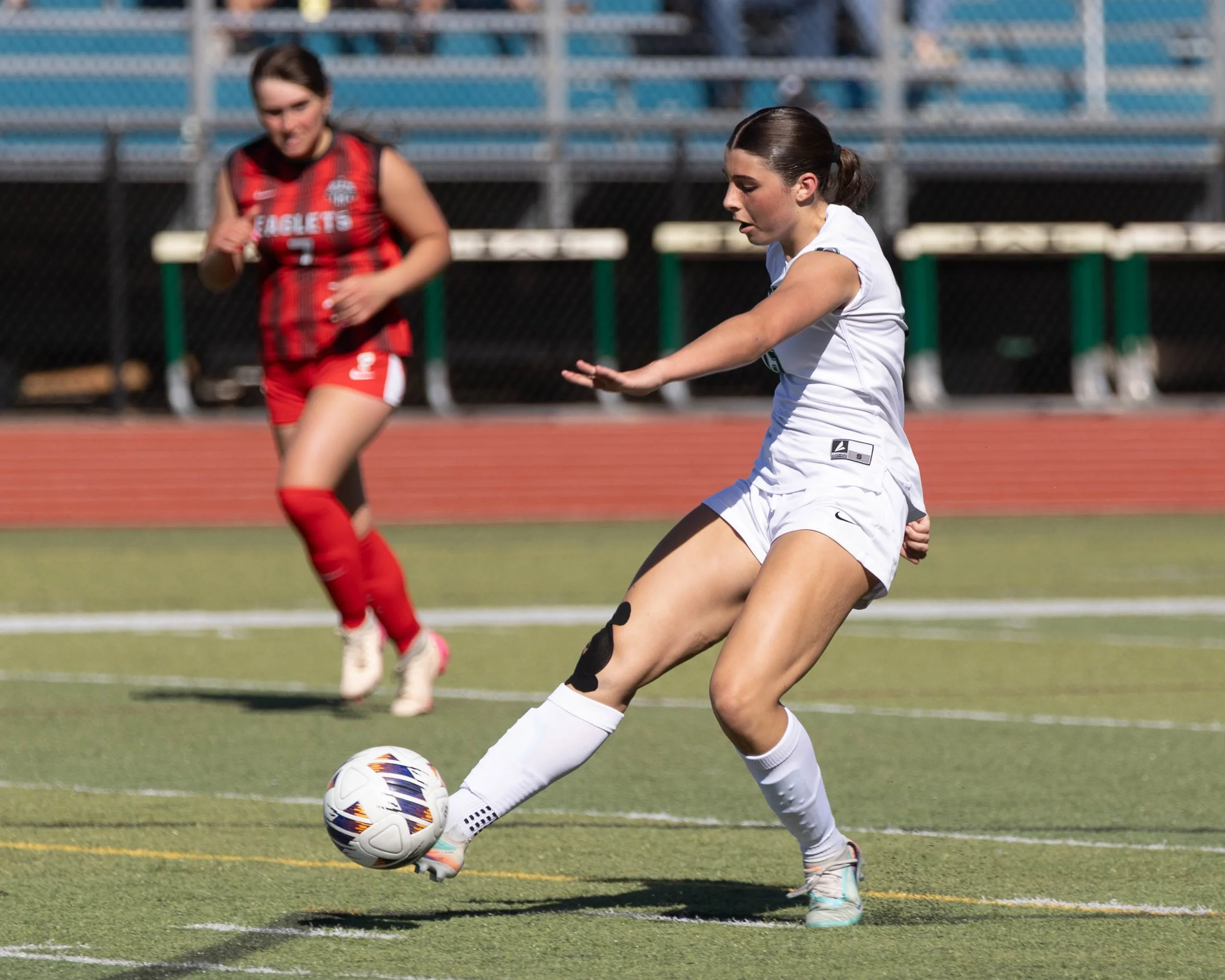 #15 with the ball on her foot and scores
