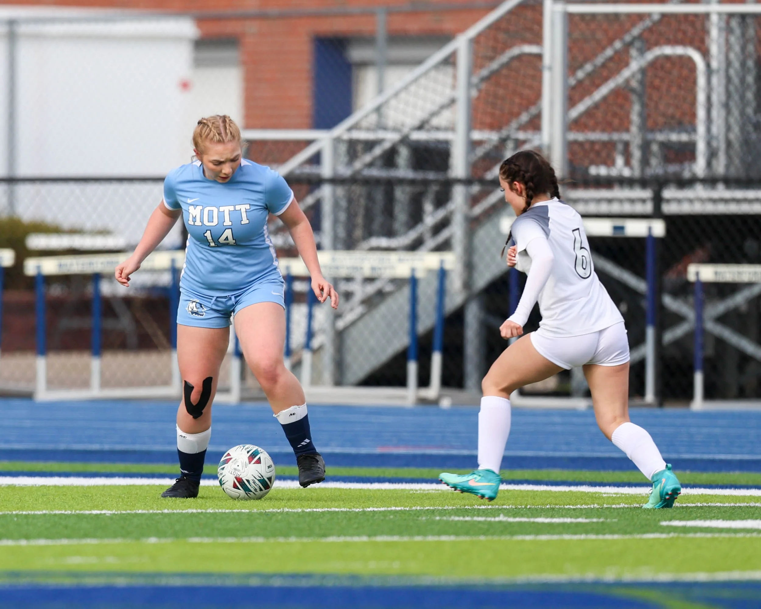 #24 with the ball between her feet