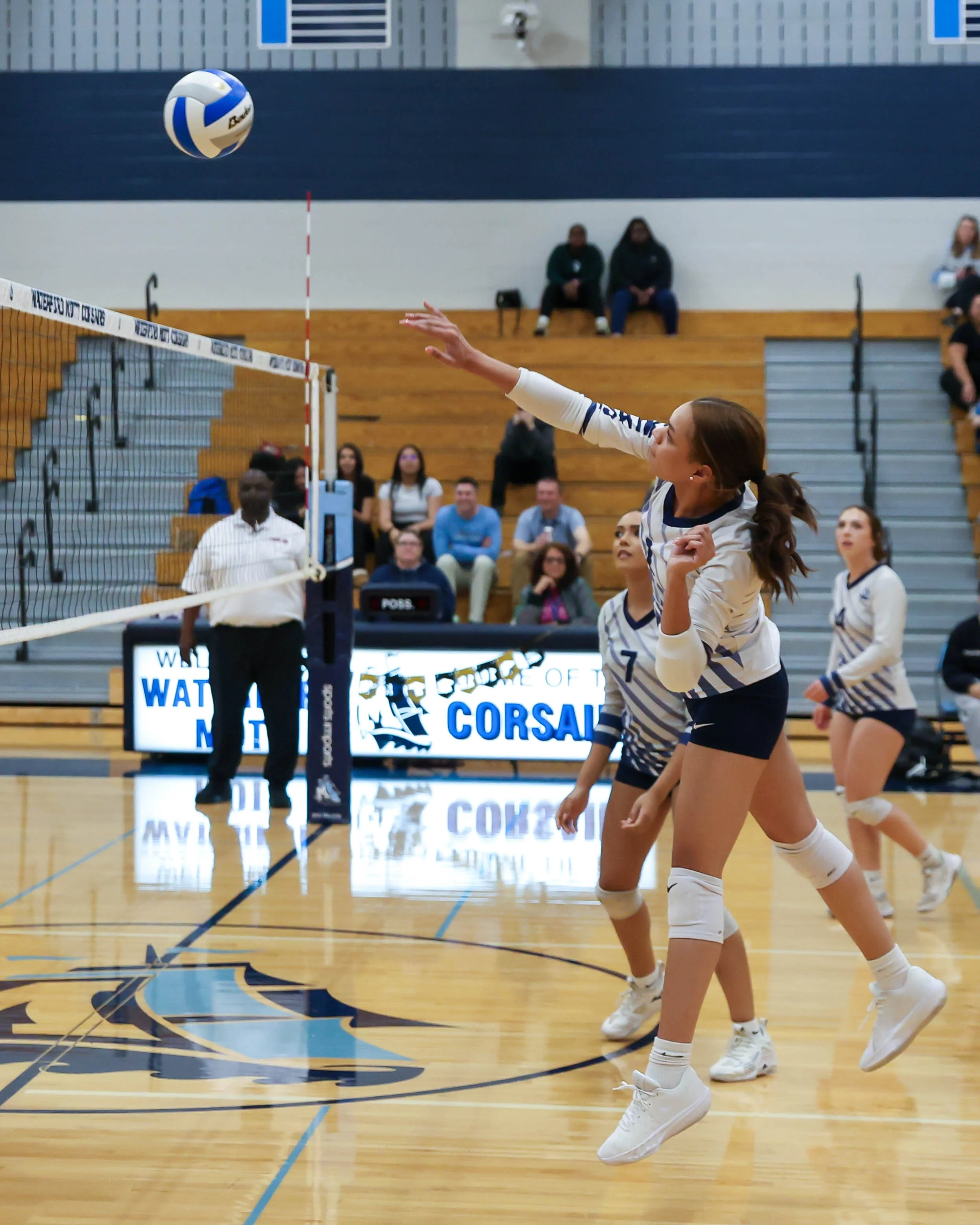 Mott #1 has the ball over the net