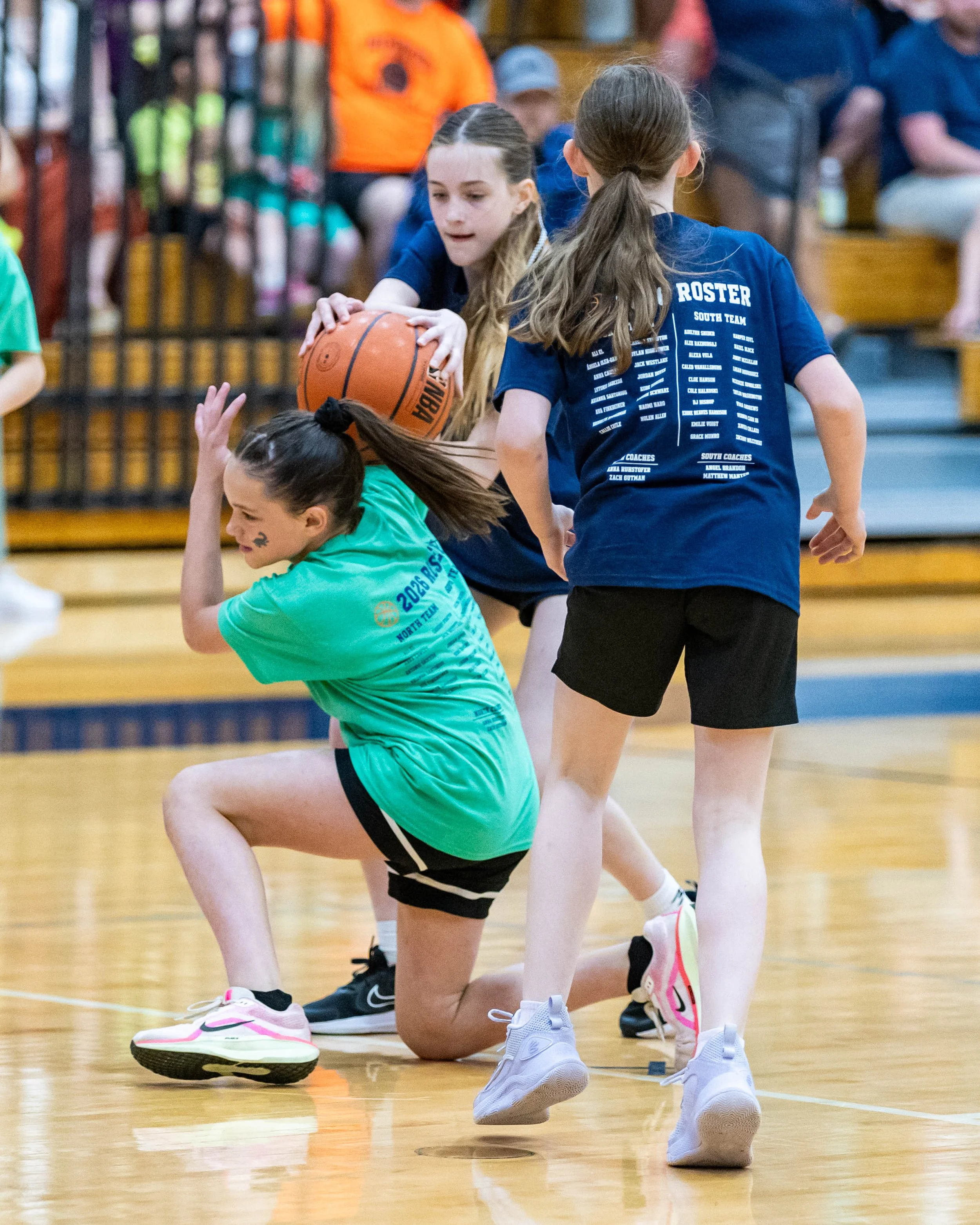 South girl fights for the ball with North girl