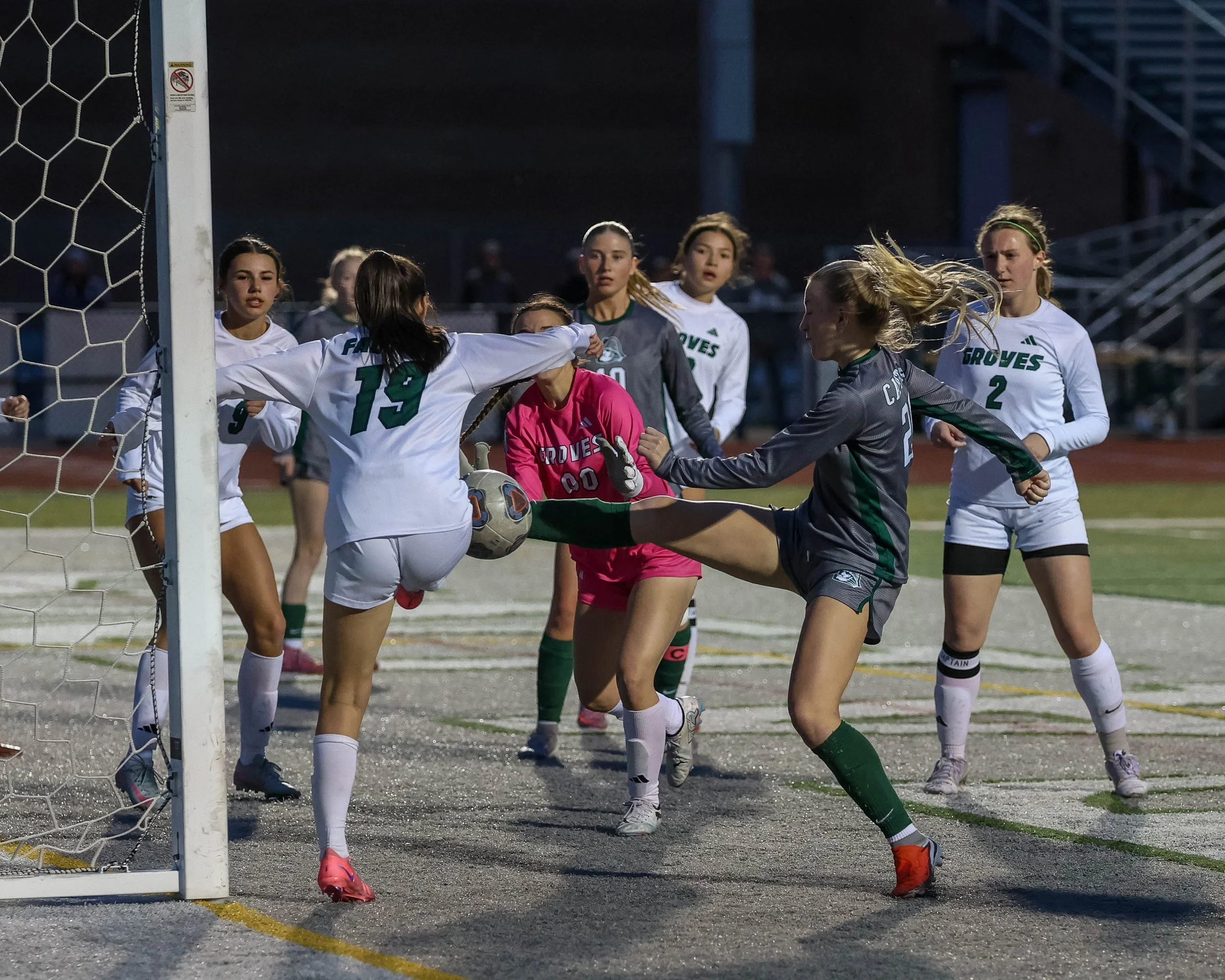 #24 kicks the ball towards the goal