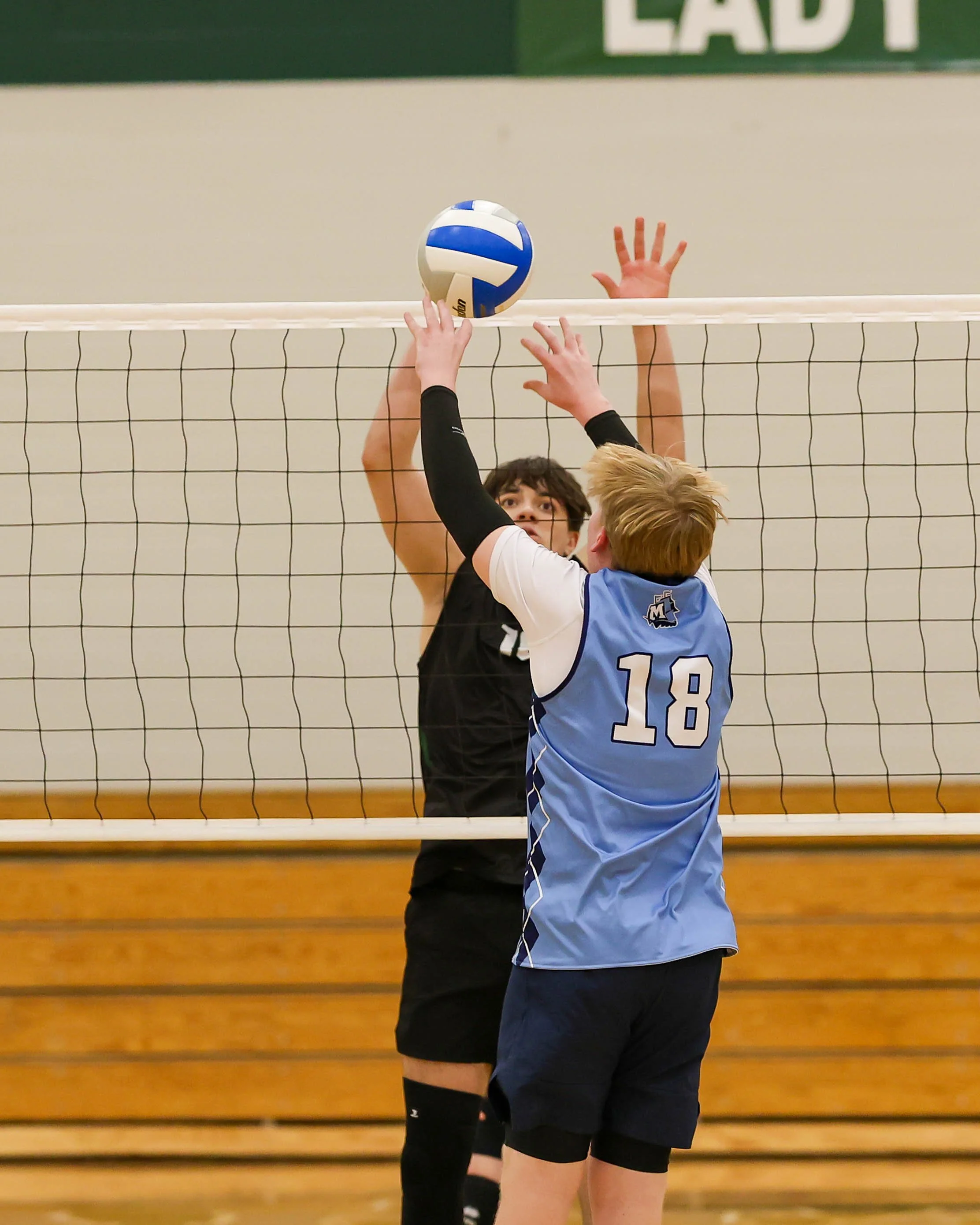 Mott #18 pushes the ball over the net