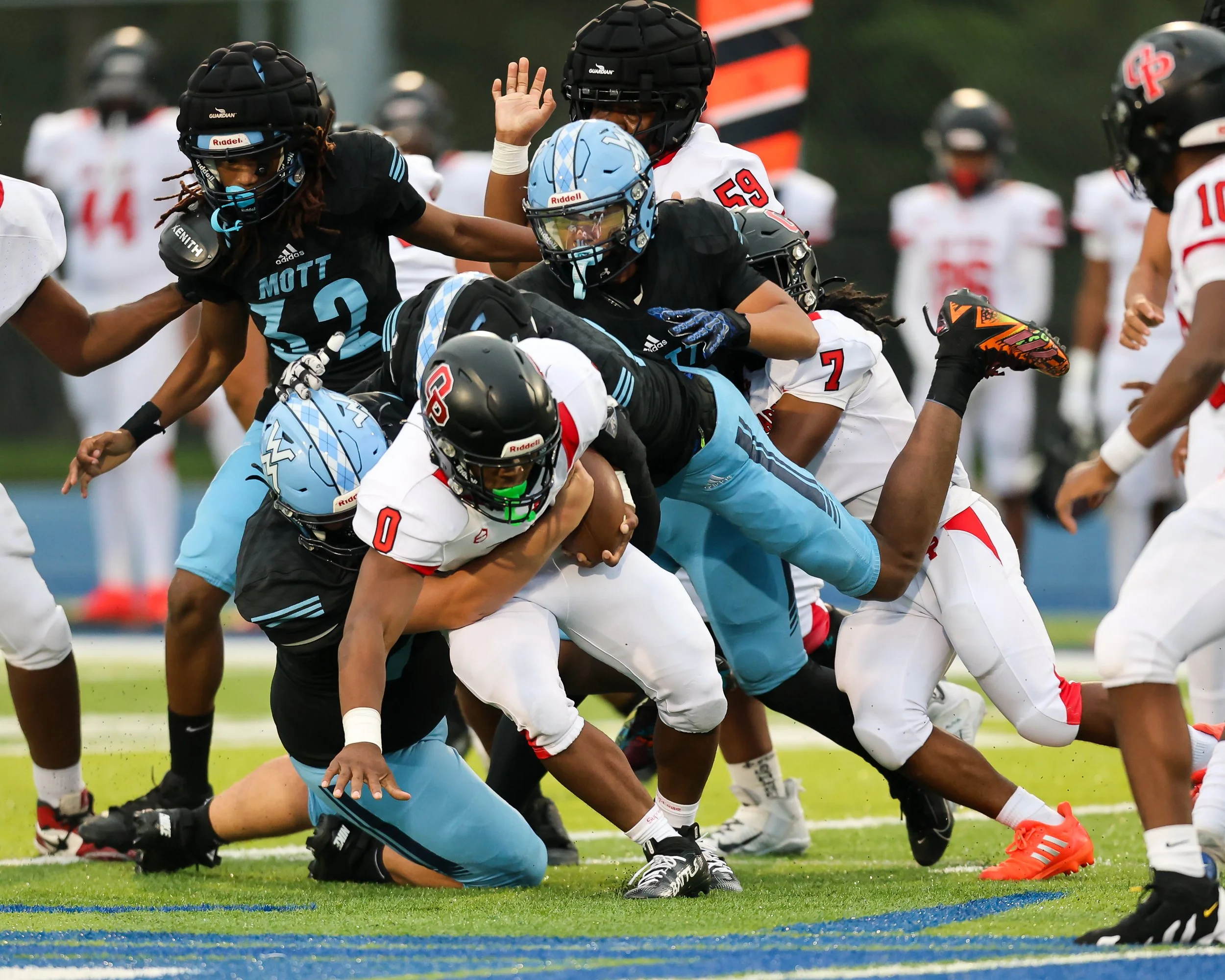 WK #75 and a host of WK players tackle the runner