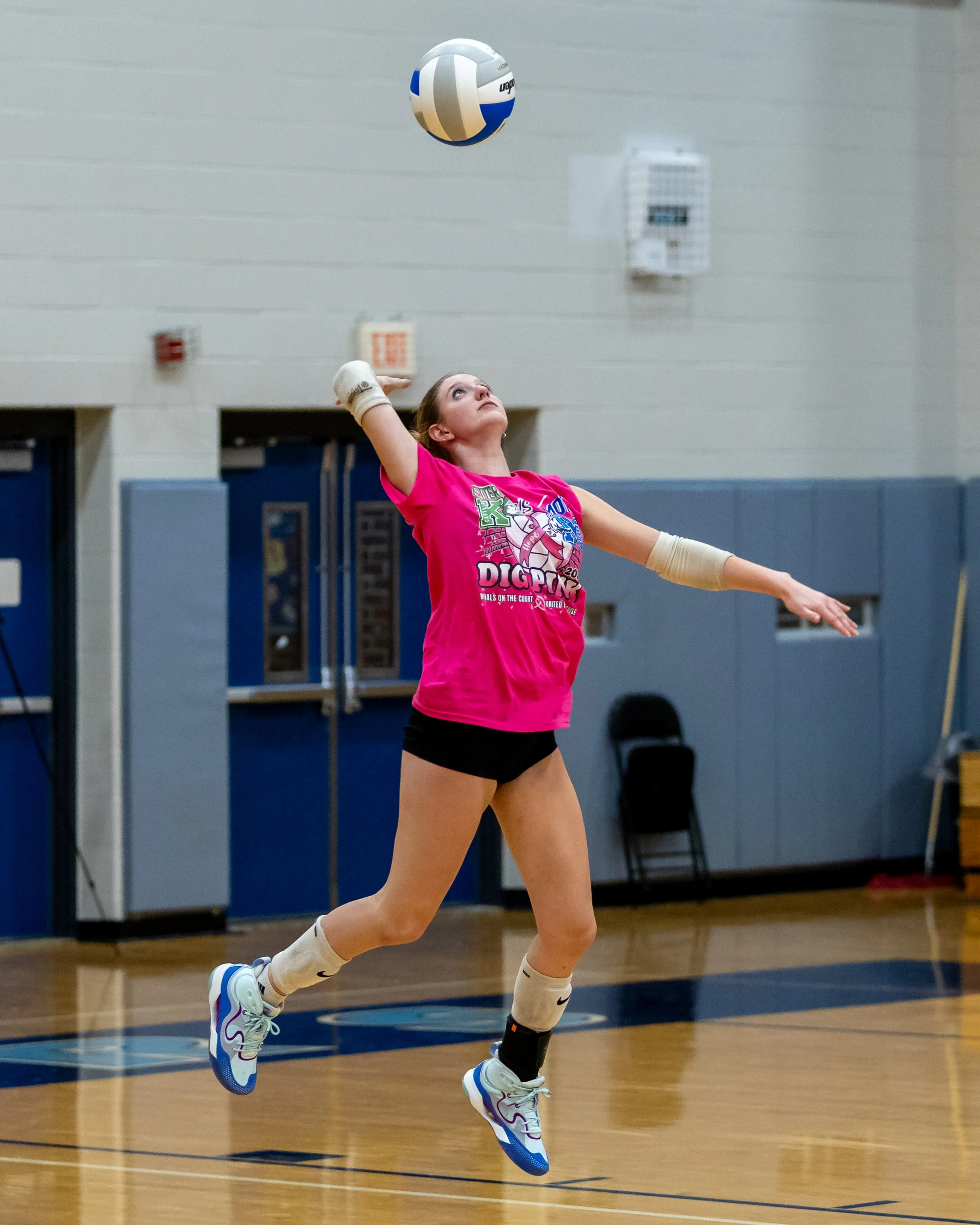 Kettering player serves the ball