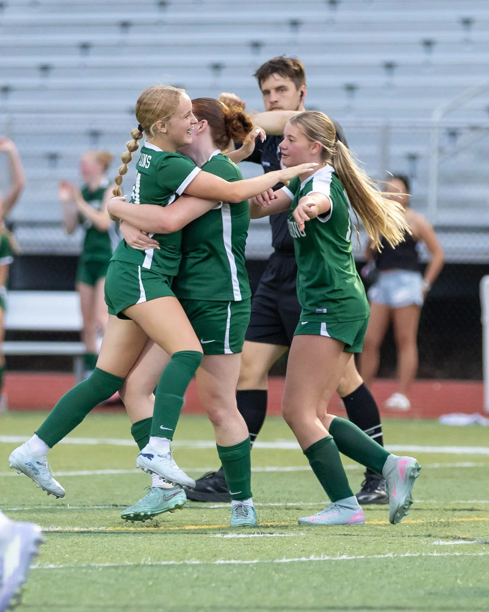 #21 celebrates the gain with teammates