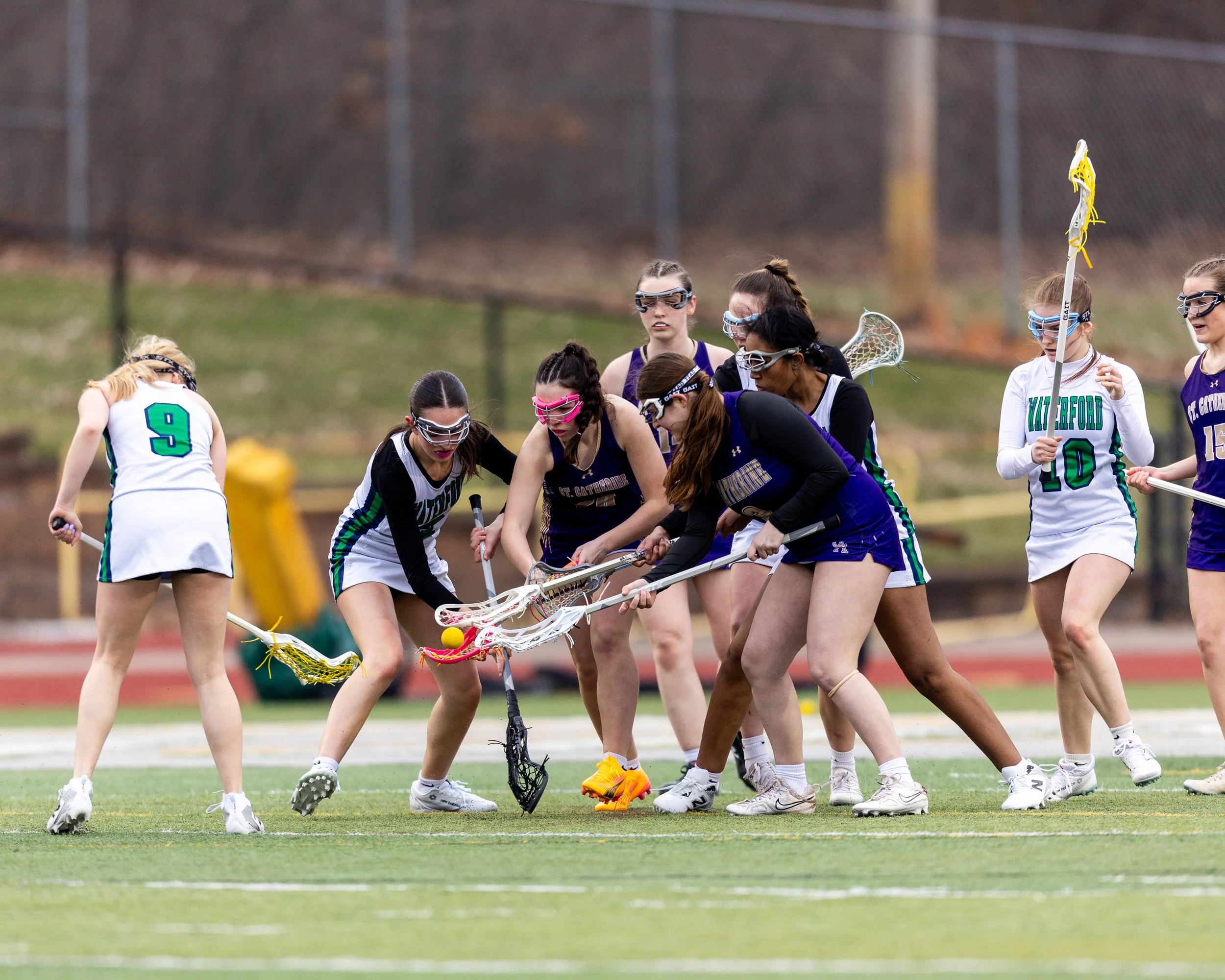 #5 fights for the ball with a group of players around her