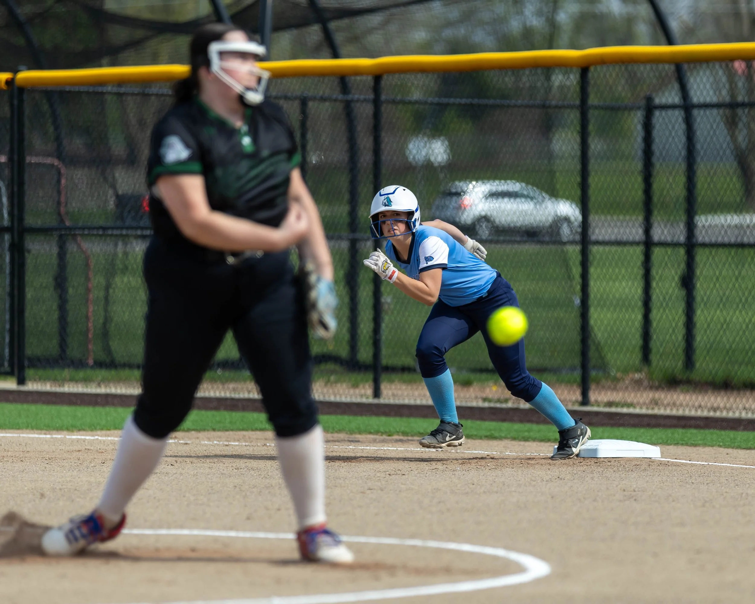 Mott runner on first base while Kettering pitcher throws ball