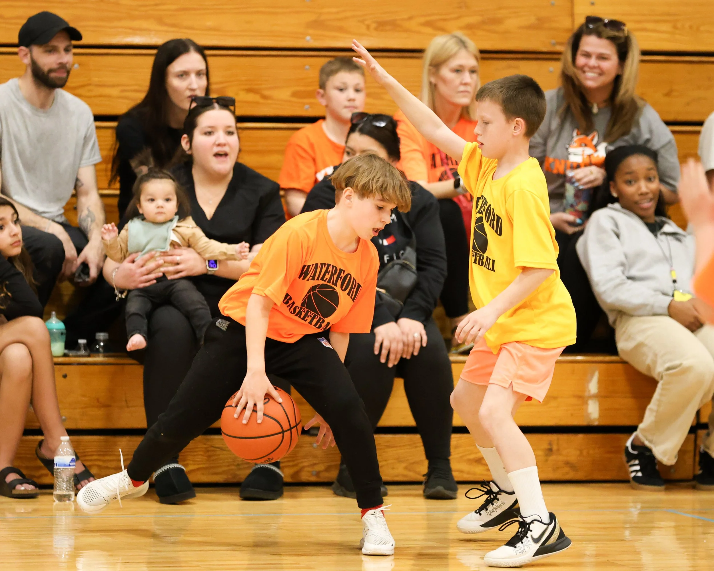Knudsen boy dribbles the ball guarded by Schoolcraft boy