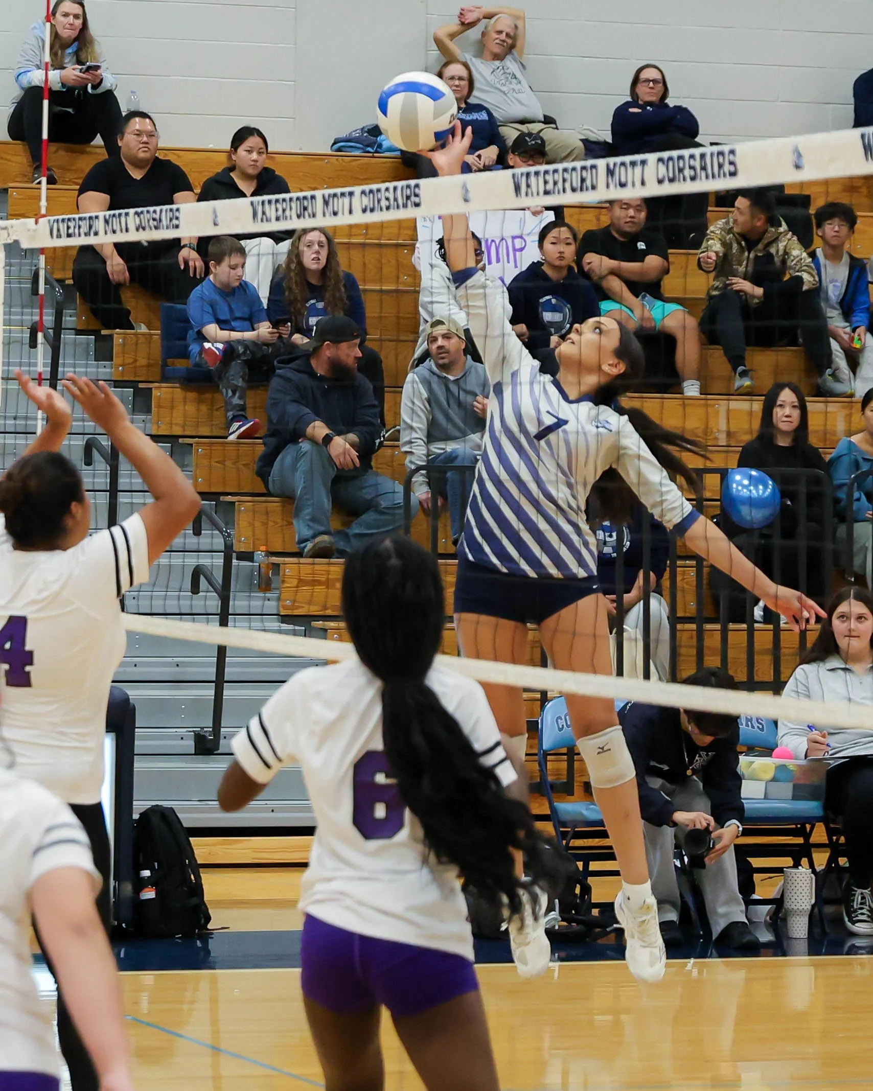 Mott #7 taps the ball over the net