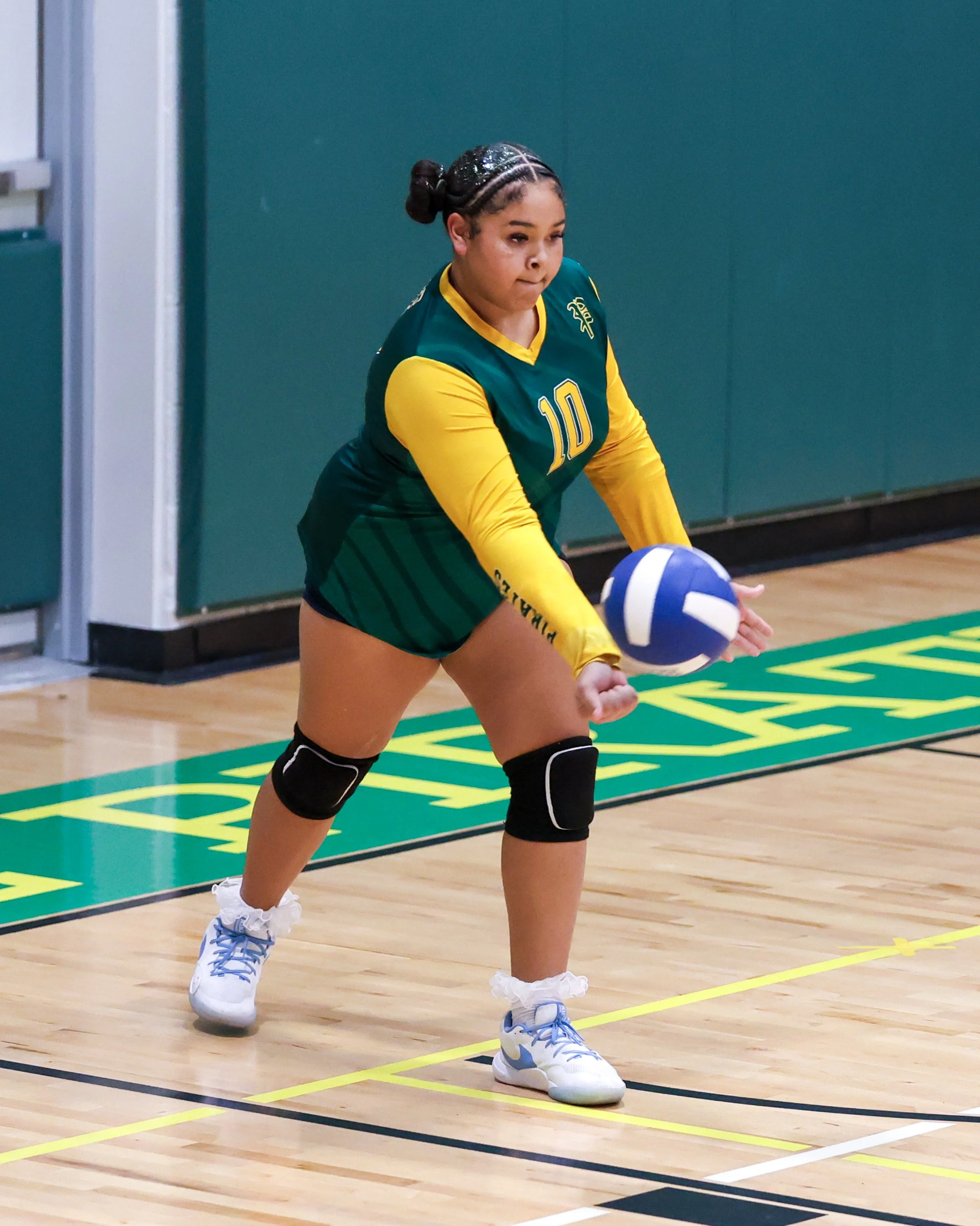 Pierce girl serves the ball