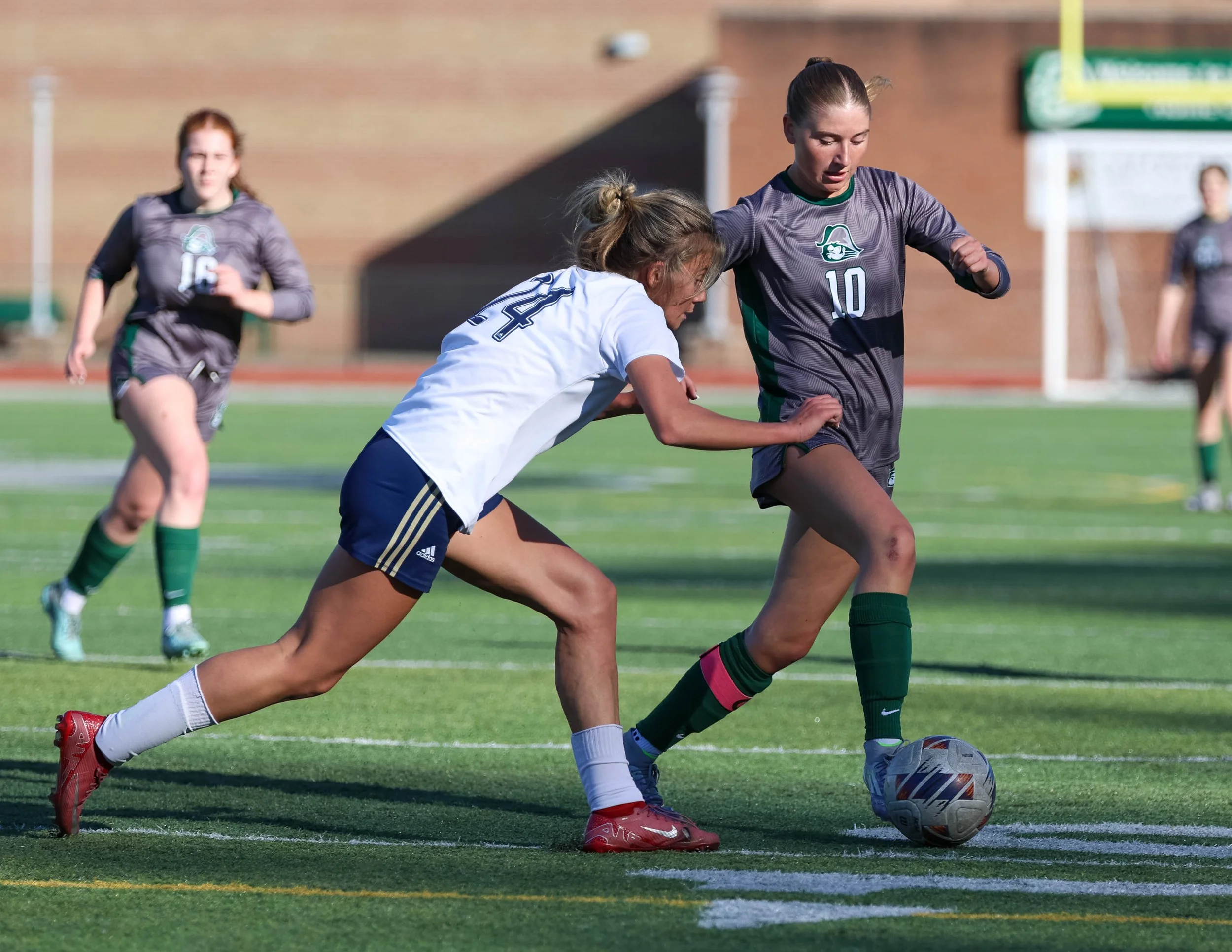 #10 crosses the field with the ball