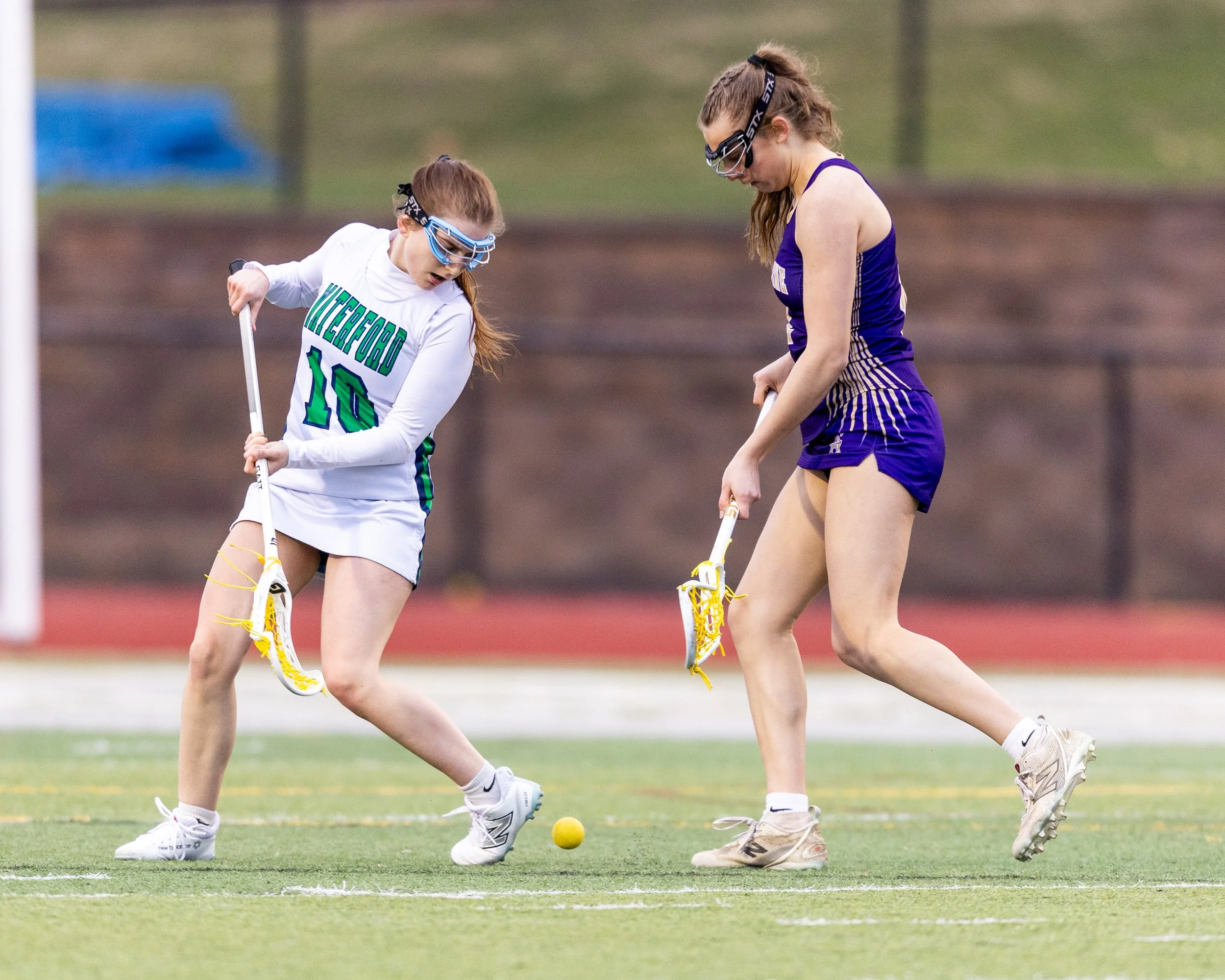 #10 and a defender look at the ball