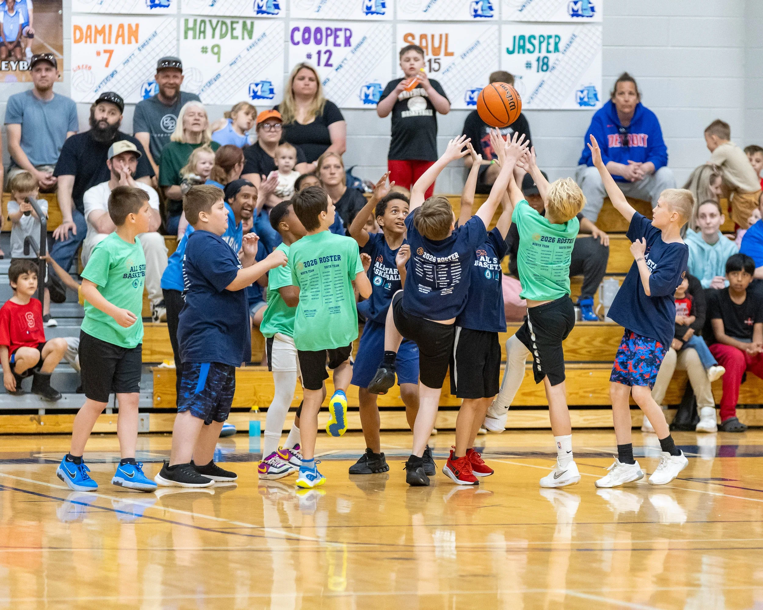South boy shoots the ball guarded by North boy