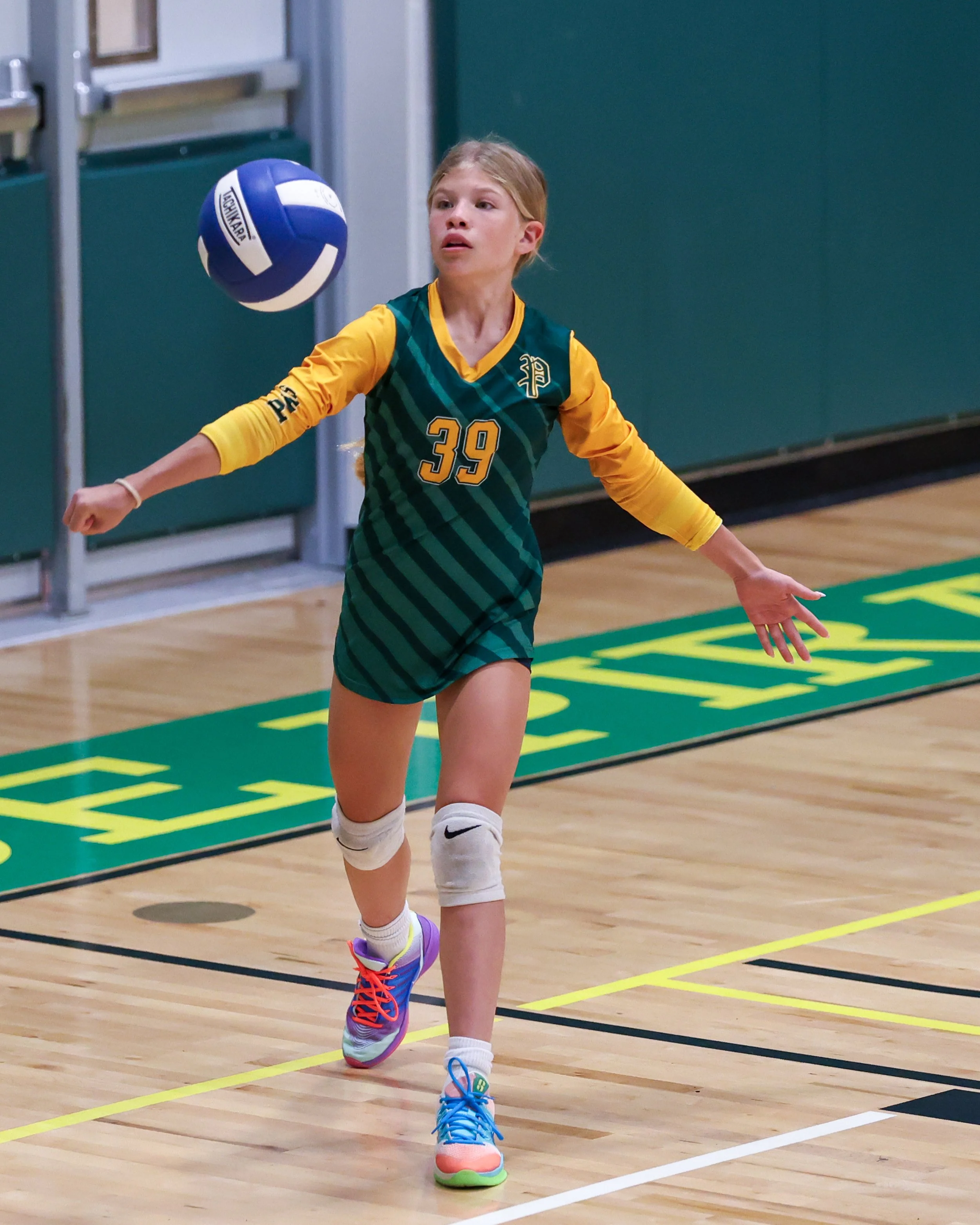 Pierce girl serves the ball