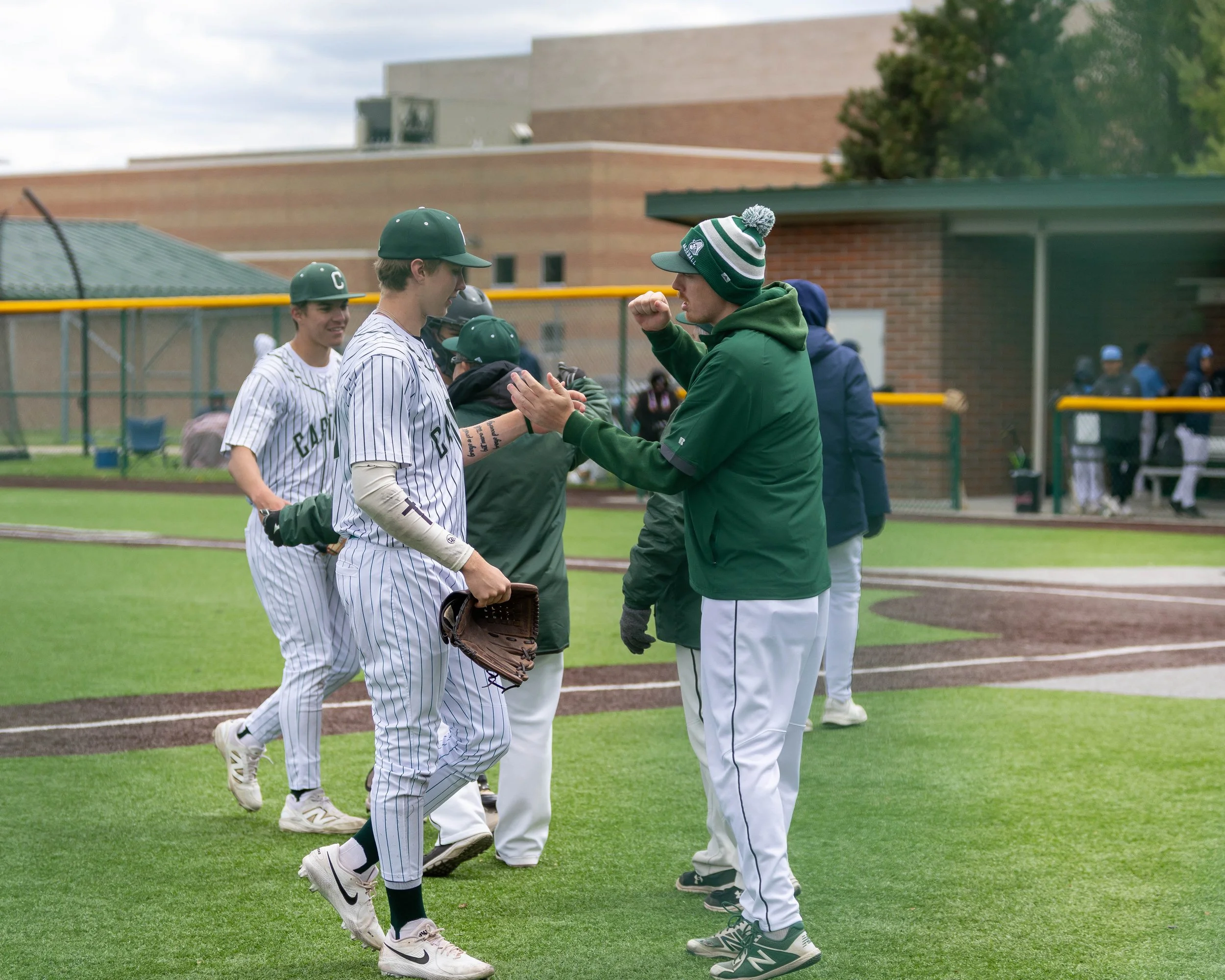 Kettering pitching coach congratulates pitcher