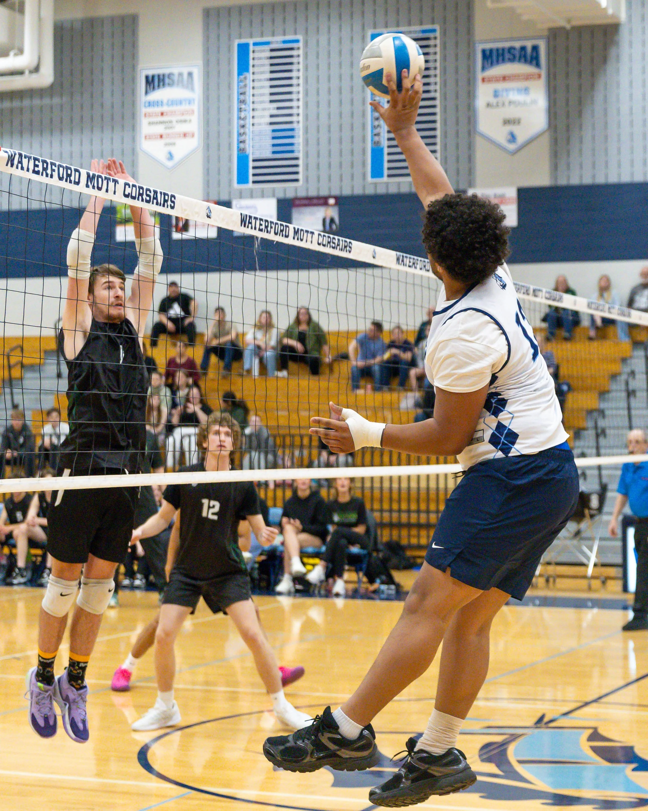 Mott #13 spikes the ball