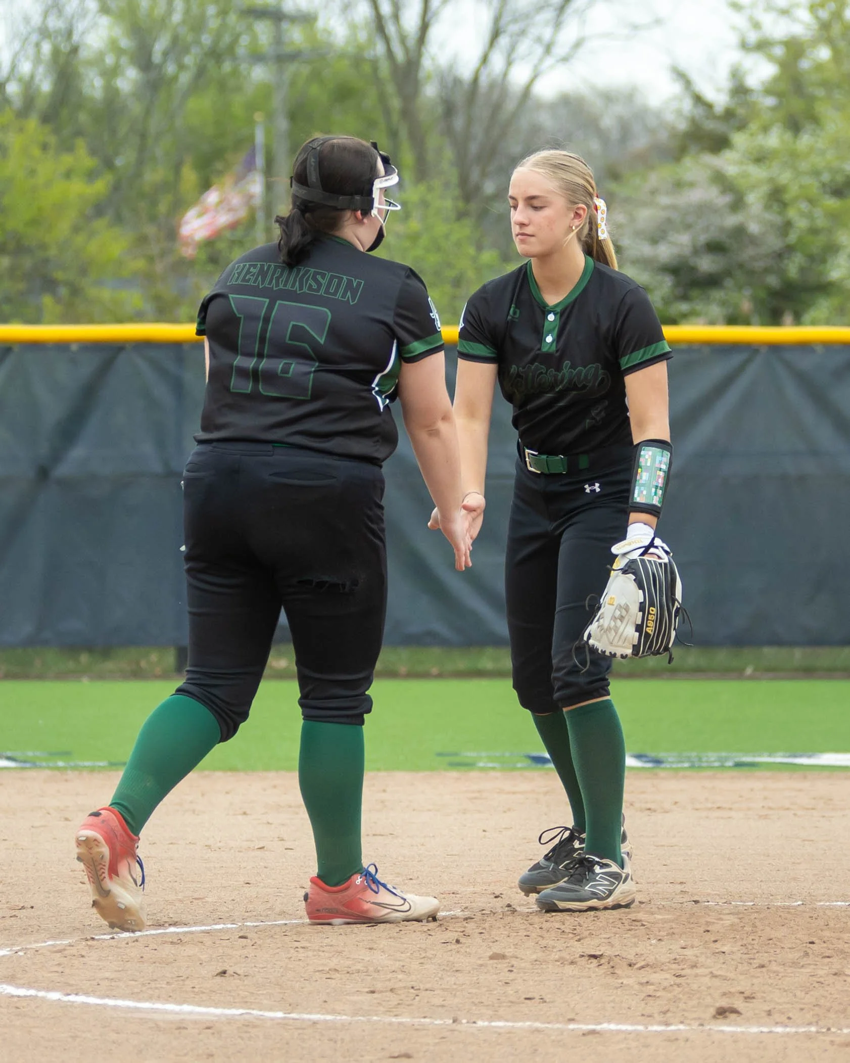 Kettering pitcher and first base shake hands after strike out