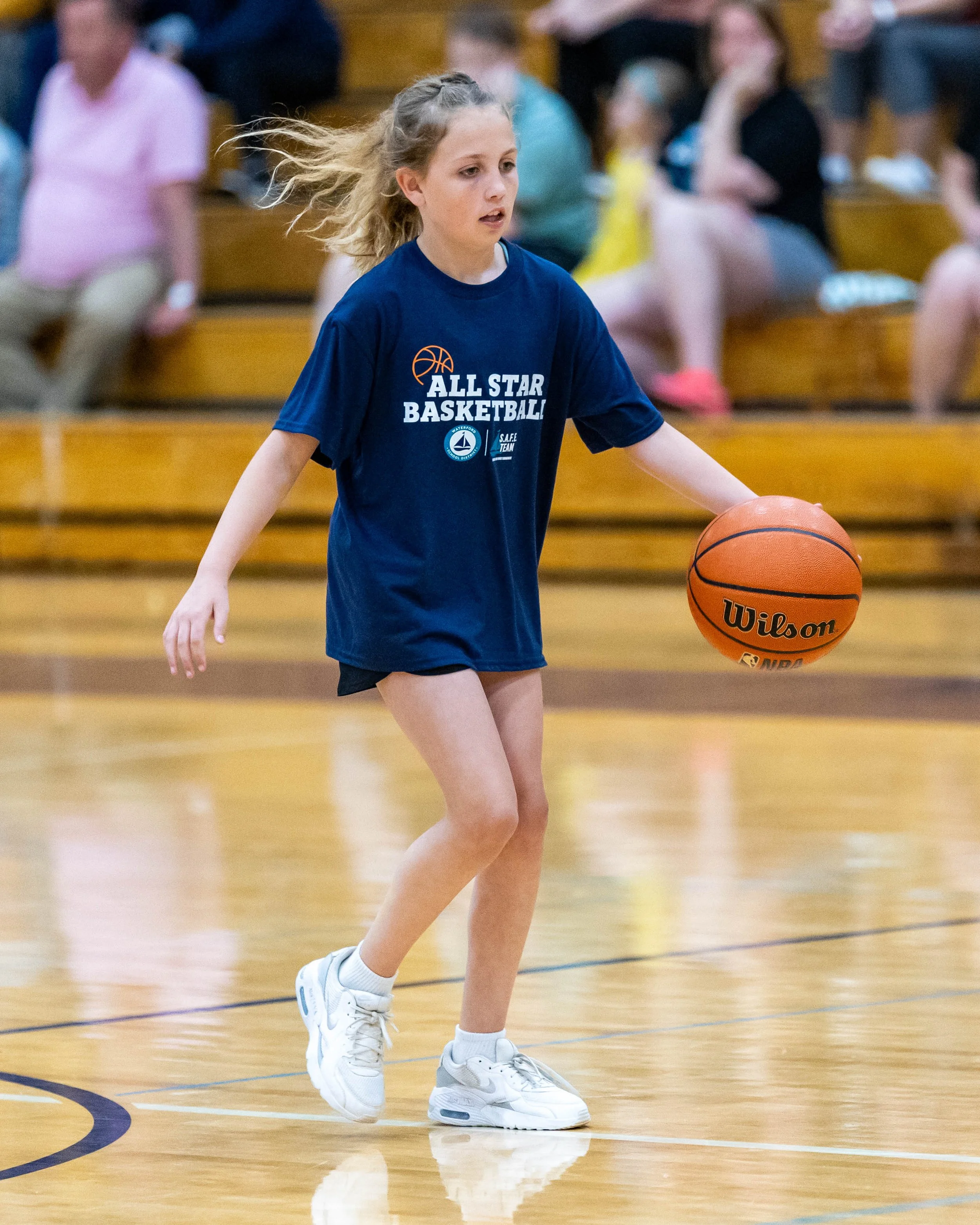 North girl dribbles the ball