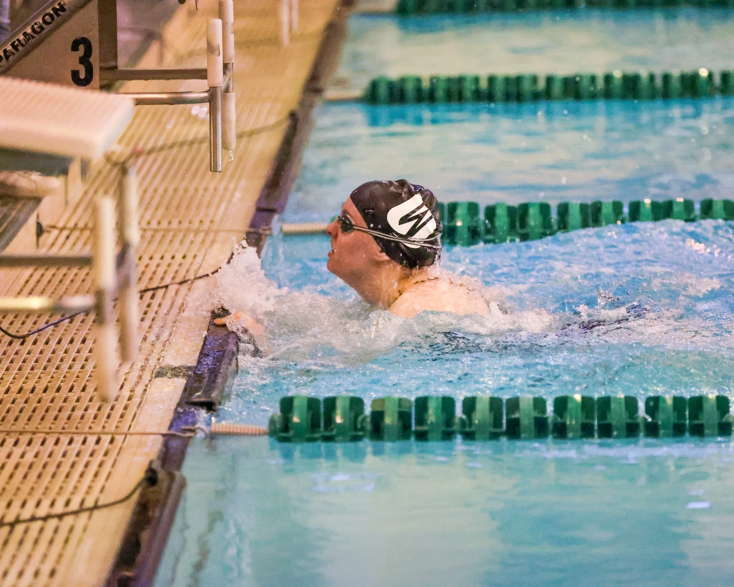 WU swimmer finishing the 100 Yard Butterfly