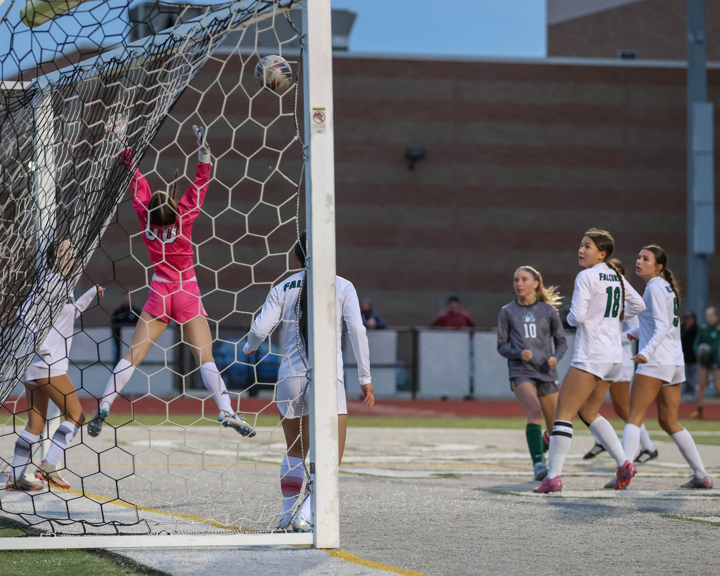 #10 kicks the ball off the post