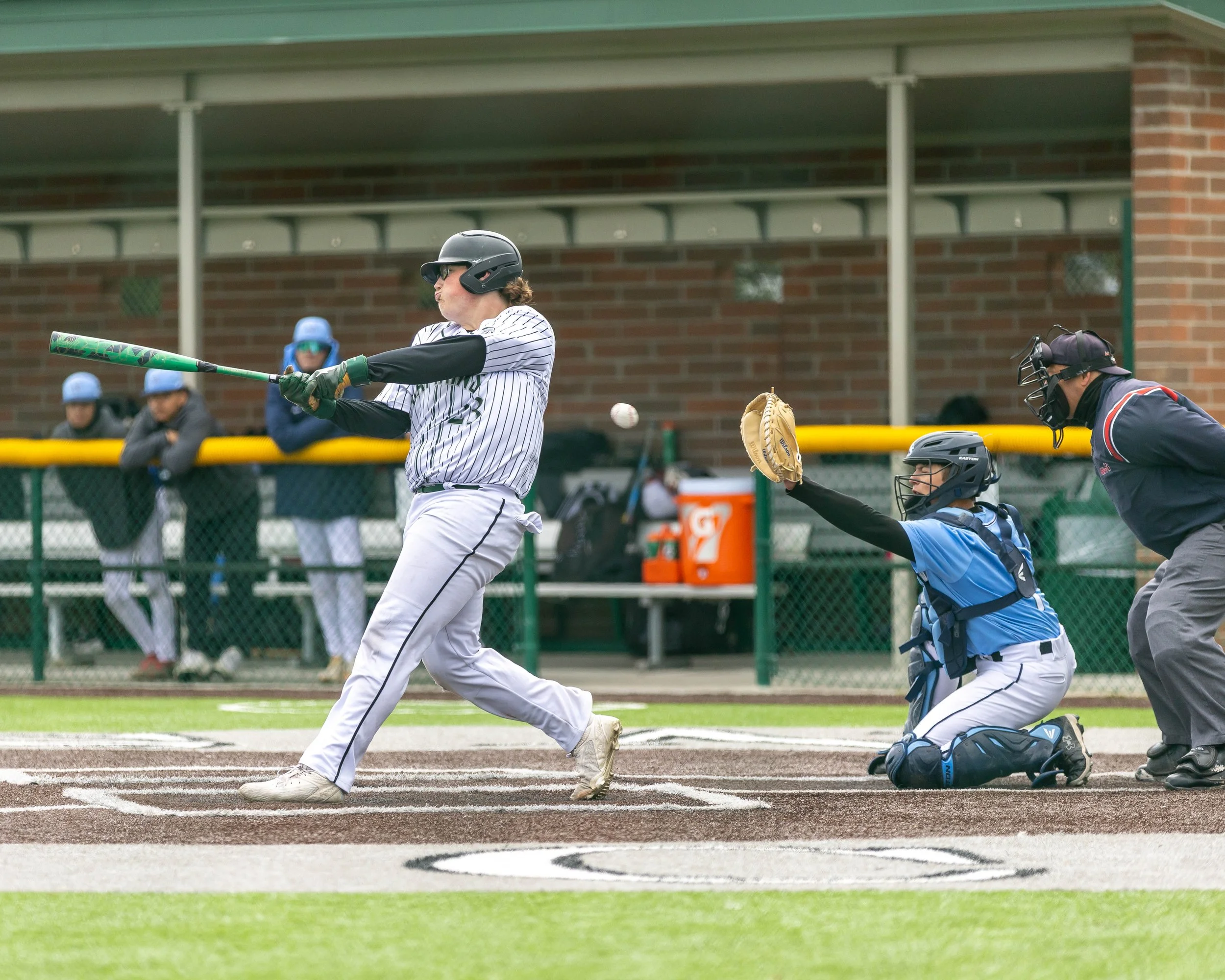 Kettering #23 swings at the ball