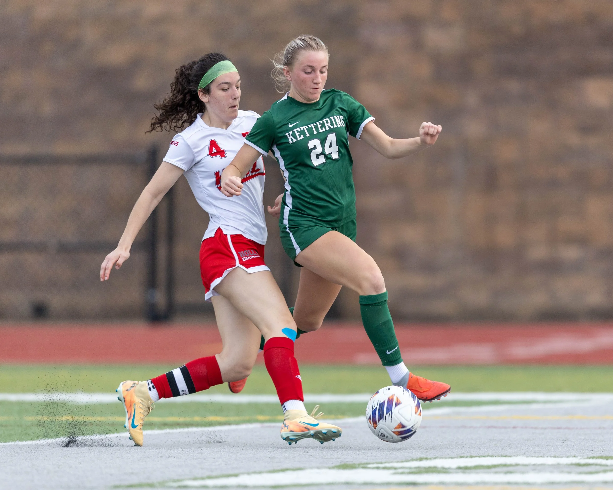 #24 dribbles the ball past a defender