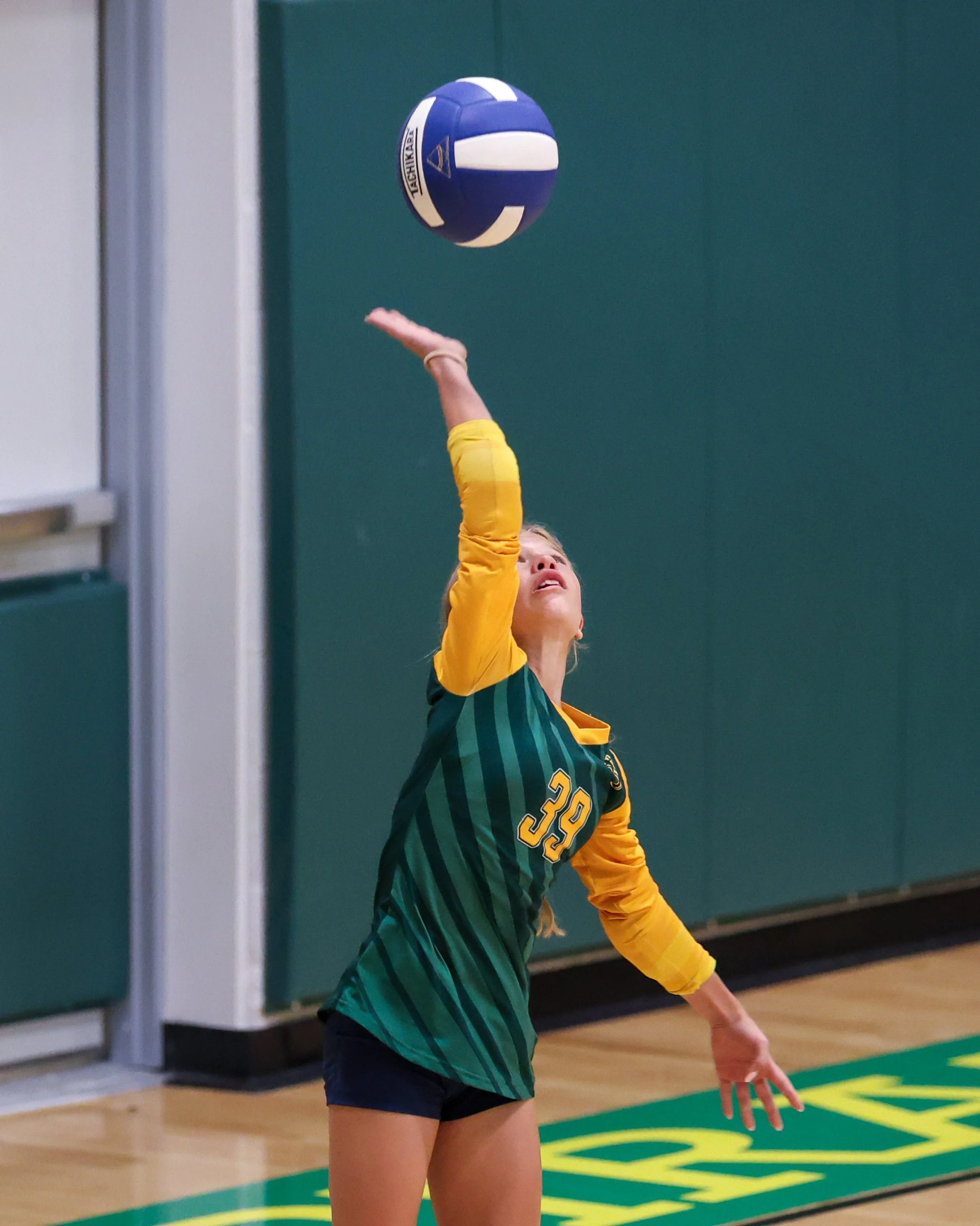 Pierce girl serves the ball