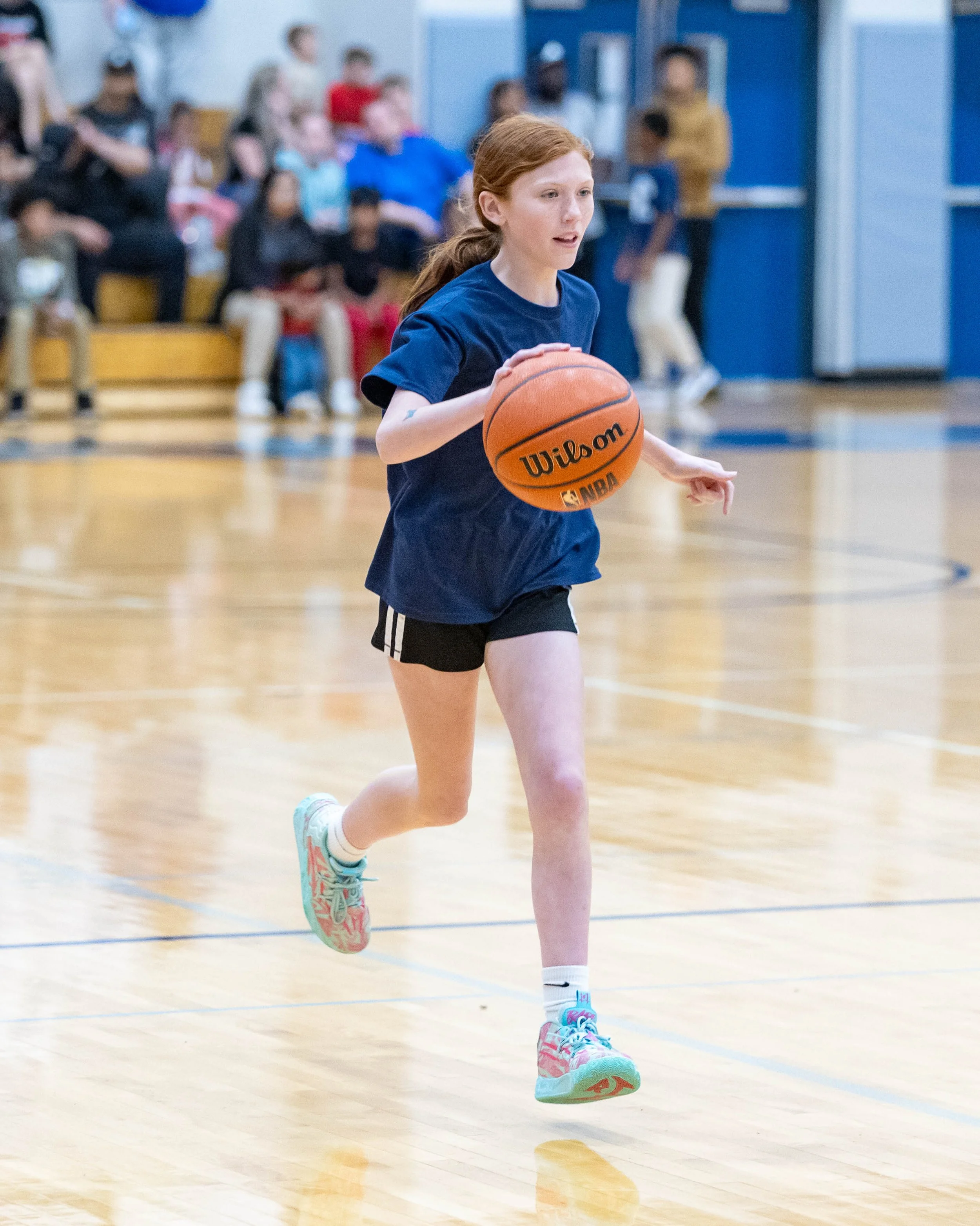 North girl dribbles the ball