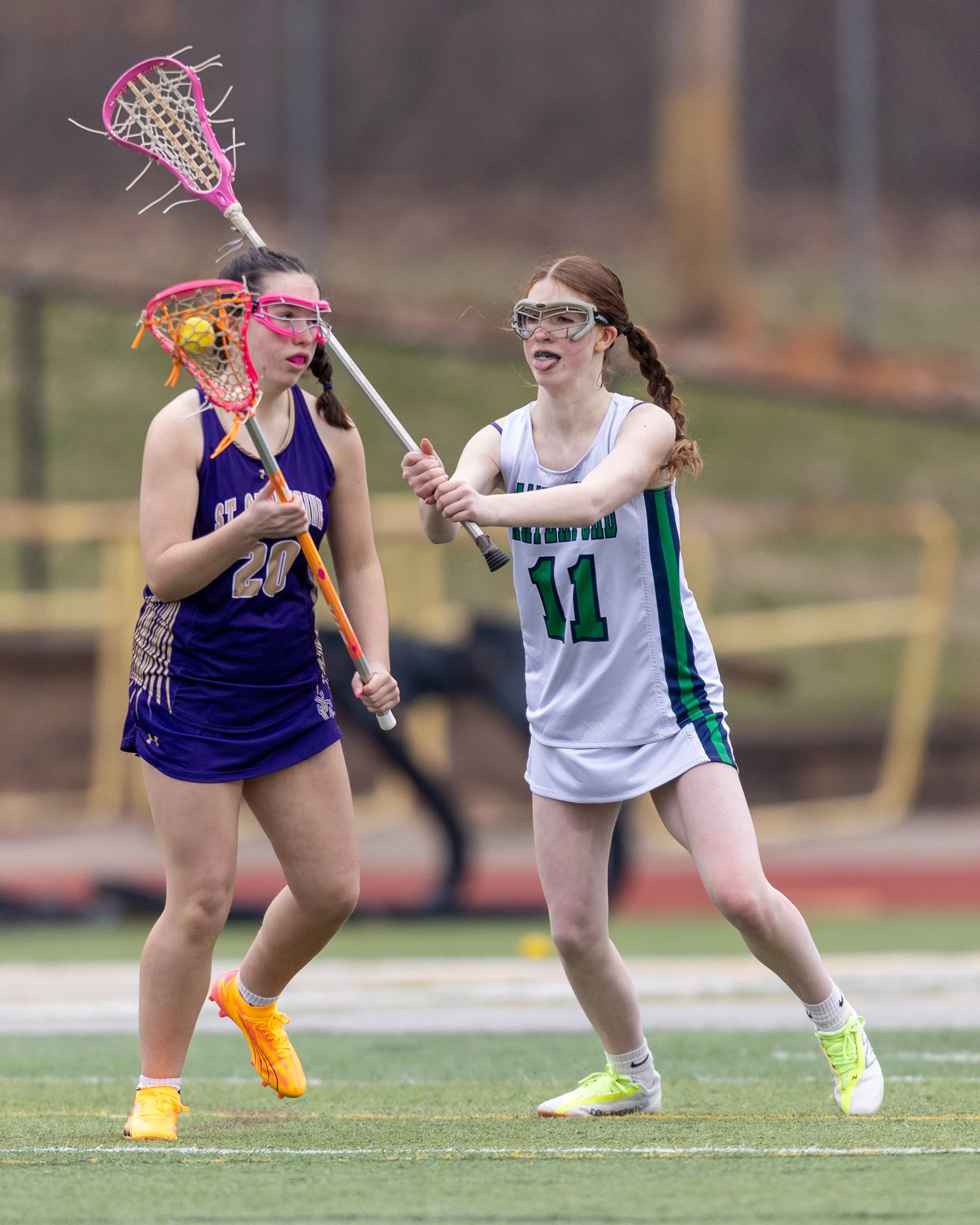 #11 defending a St. Catherine's #20 with the ball