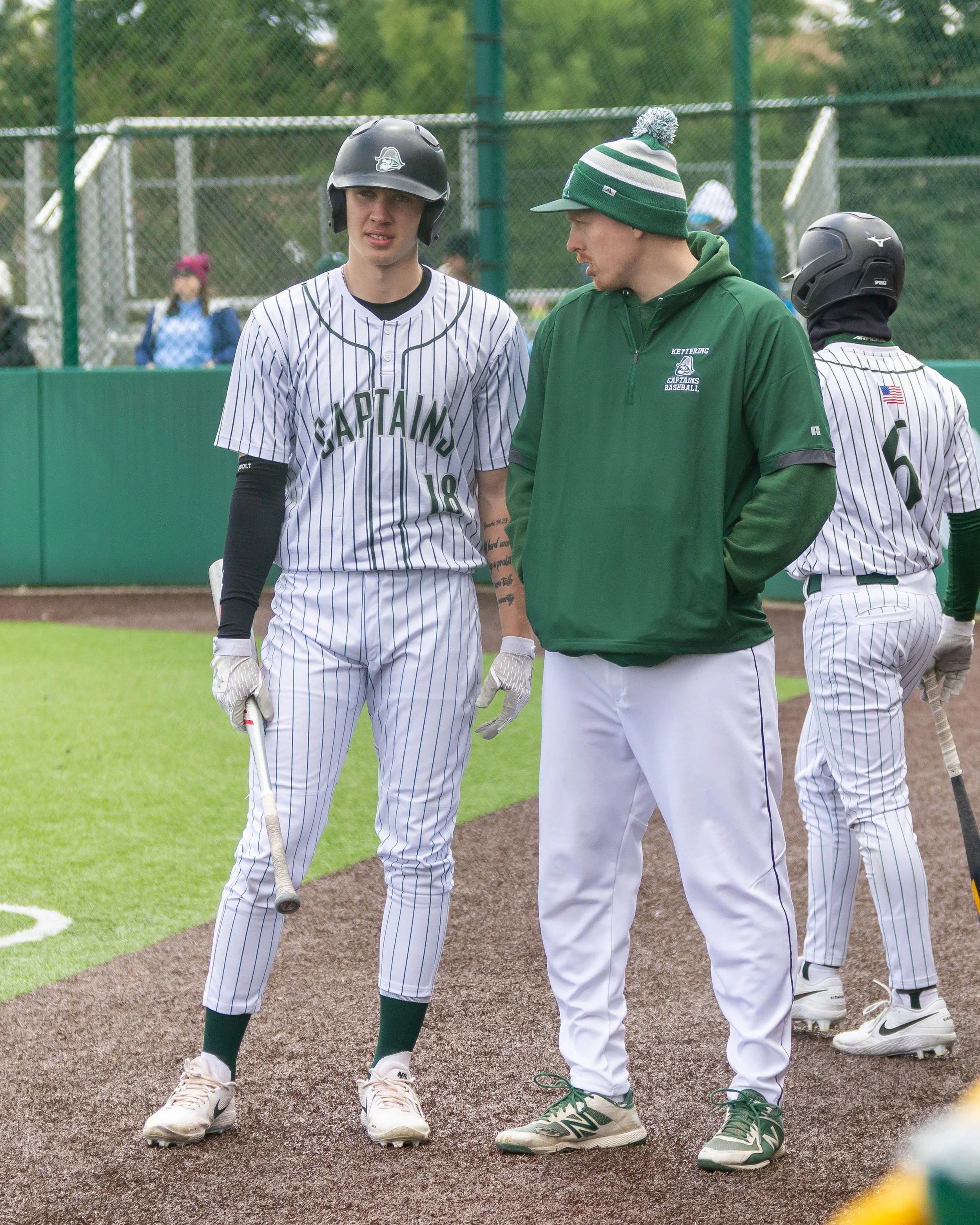 Kettering #18 talks to his pitching coach