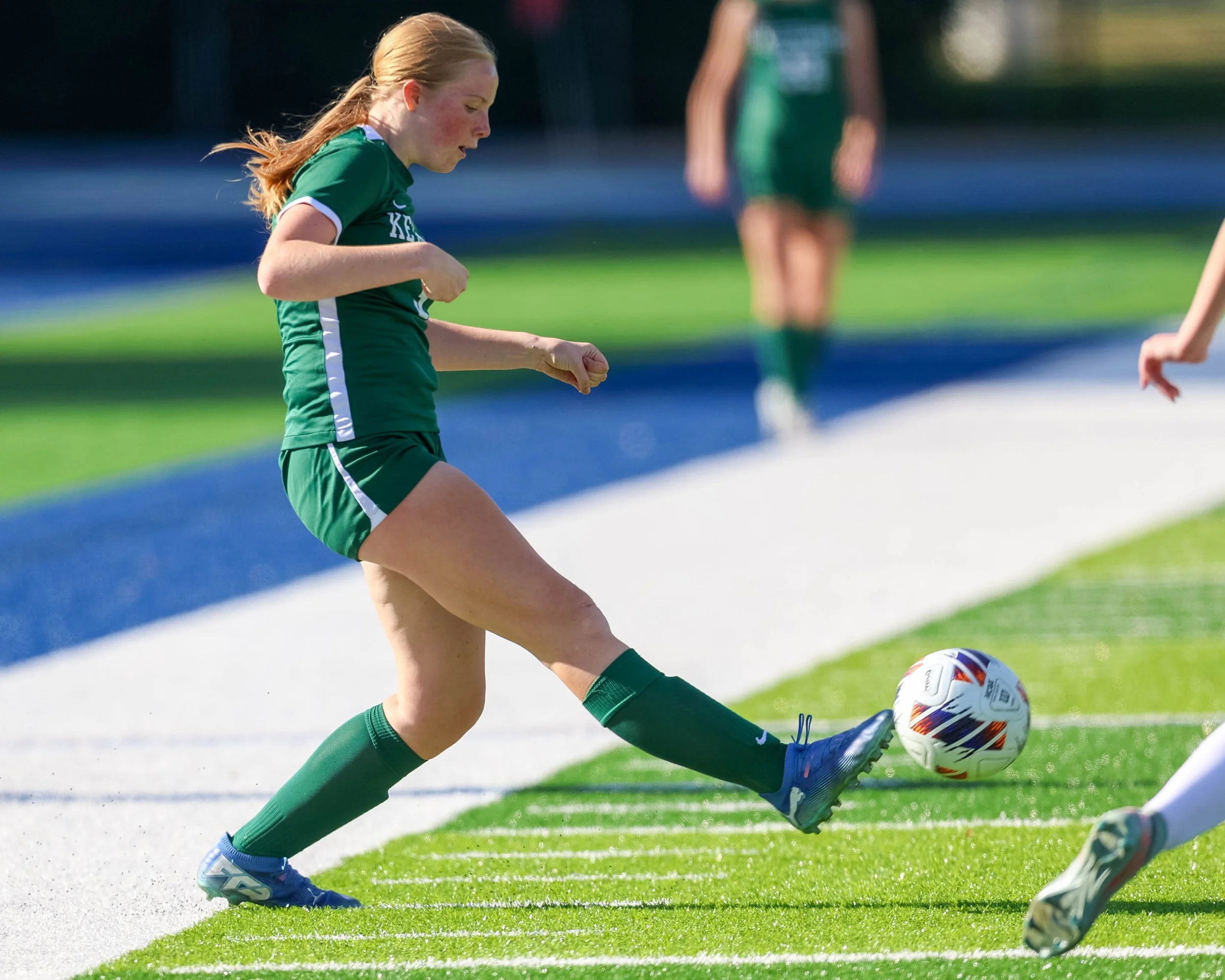#3 controls the ball with her foot